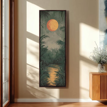 a large framed painting of a tropical landscape with a large orange sun in the sky, surrounded by lush greenery and a winding river.