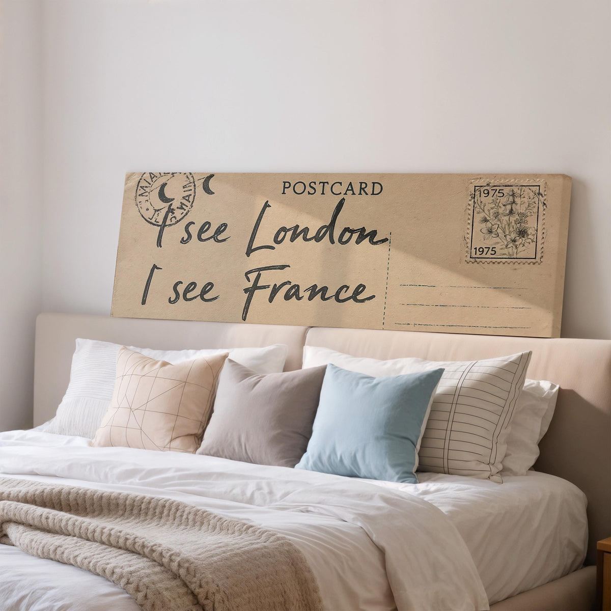 Postcard saying I see London, I see France wide panoramic canvas print above a bed in a bedroom