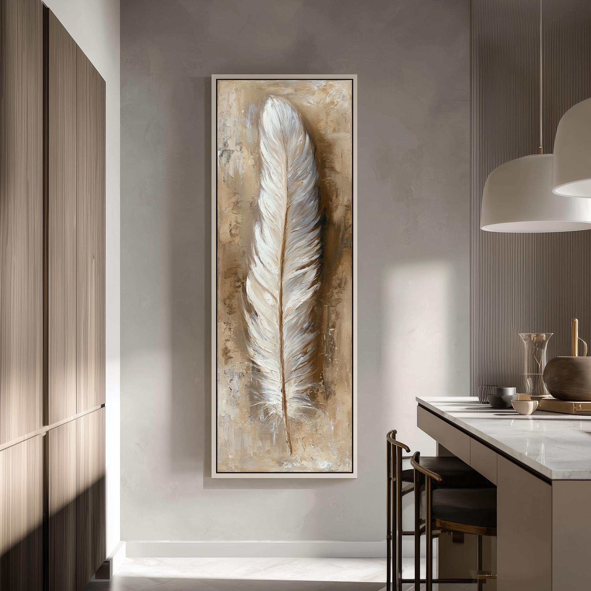 a large framed painting of a feather hanging on a wall in a modern kitchen.