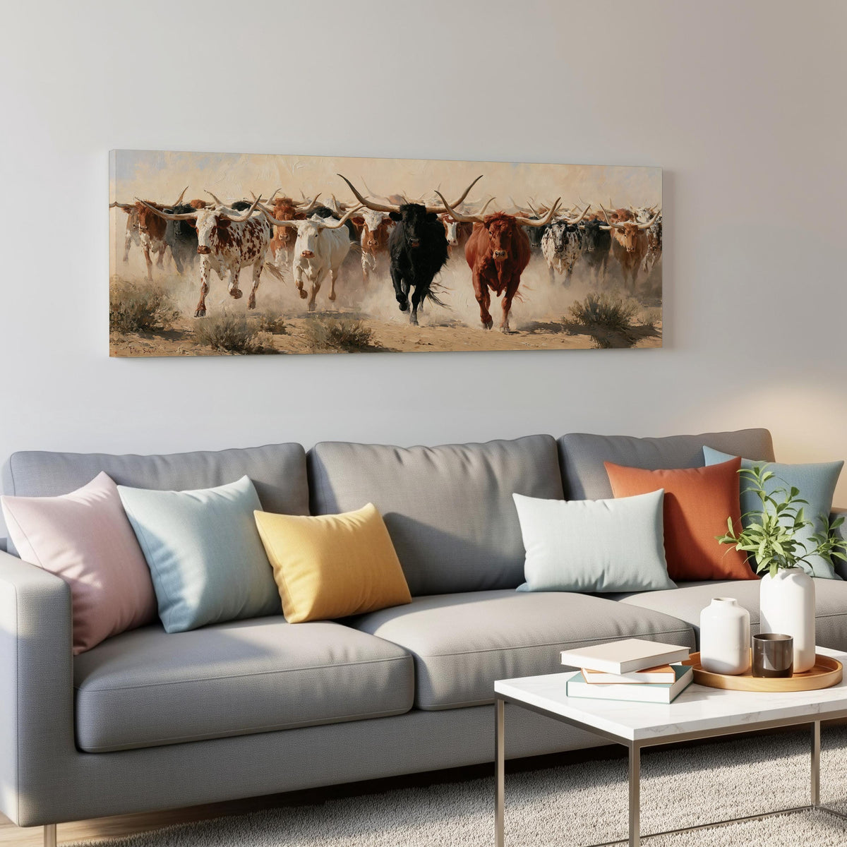 Longhorn cattle stampede panoramic canvas print above a grey sofa in a living room