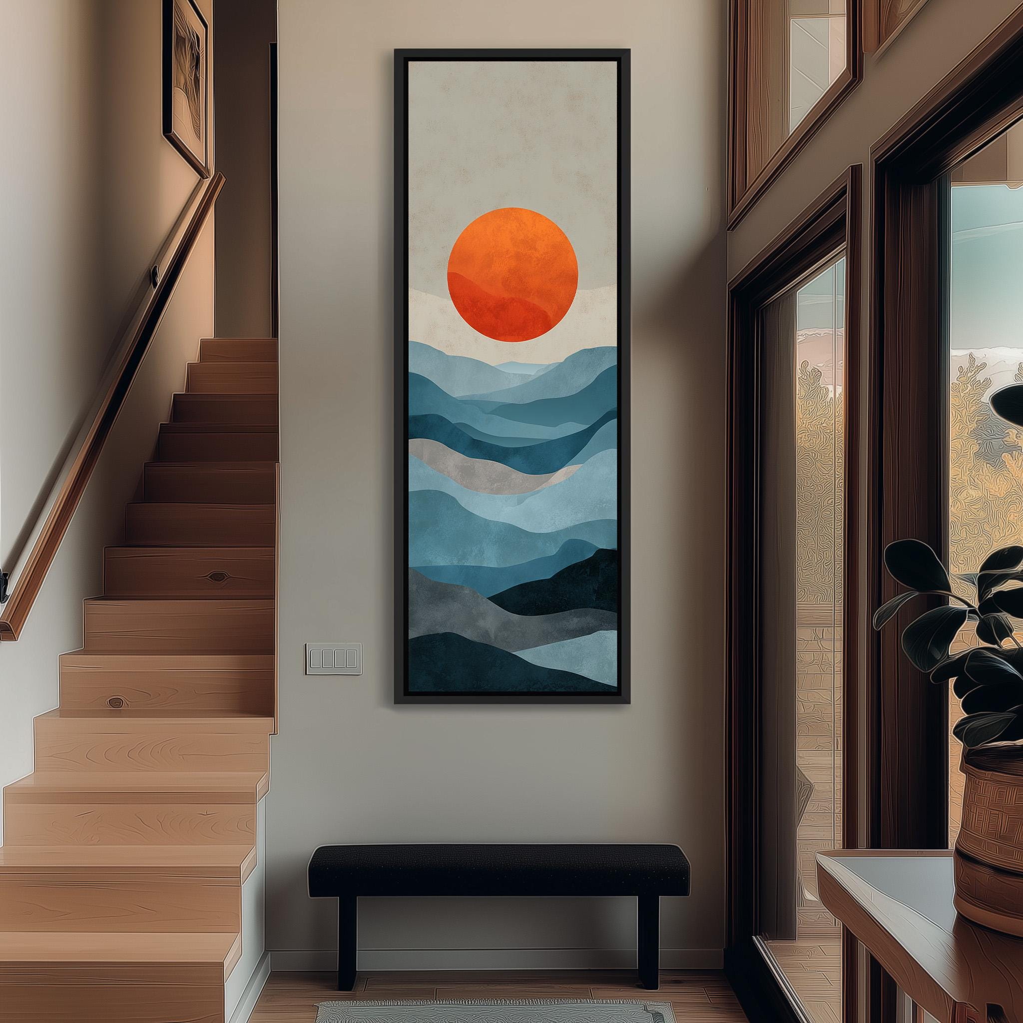 a hallway with a large painting of a mountain landscape hanging on the wall. The painting has a vibrant orange sun in the center, surrounded by a blue and gray mountain range. The hallway has wooden stairs leading up to the painting, and there is a bench in front of the painting.