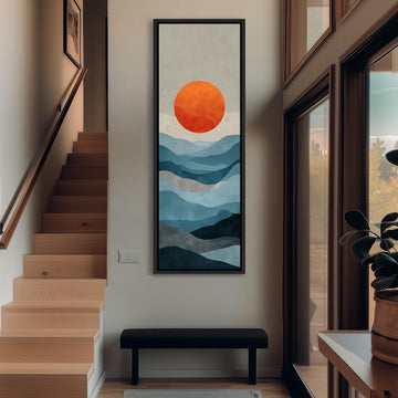 a hallway with a large painting of a mountain landscape hanging on the wall. The painting has a vibrant orange sun in the center, surrounded by a blue and gray mountain range. The hallway has wooden stairs leading up to the painting, and there is a bench in front of the painting.
