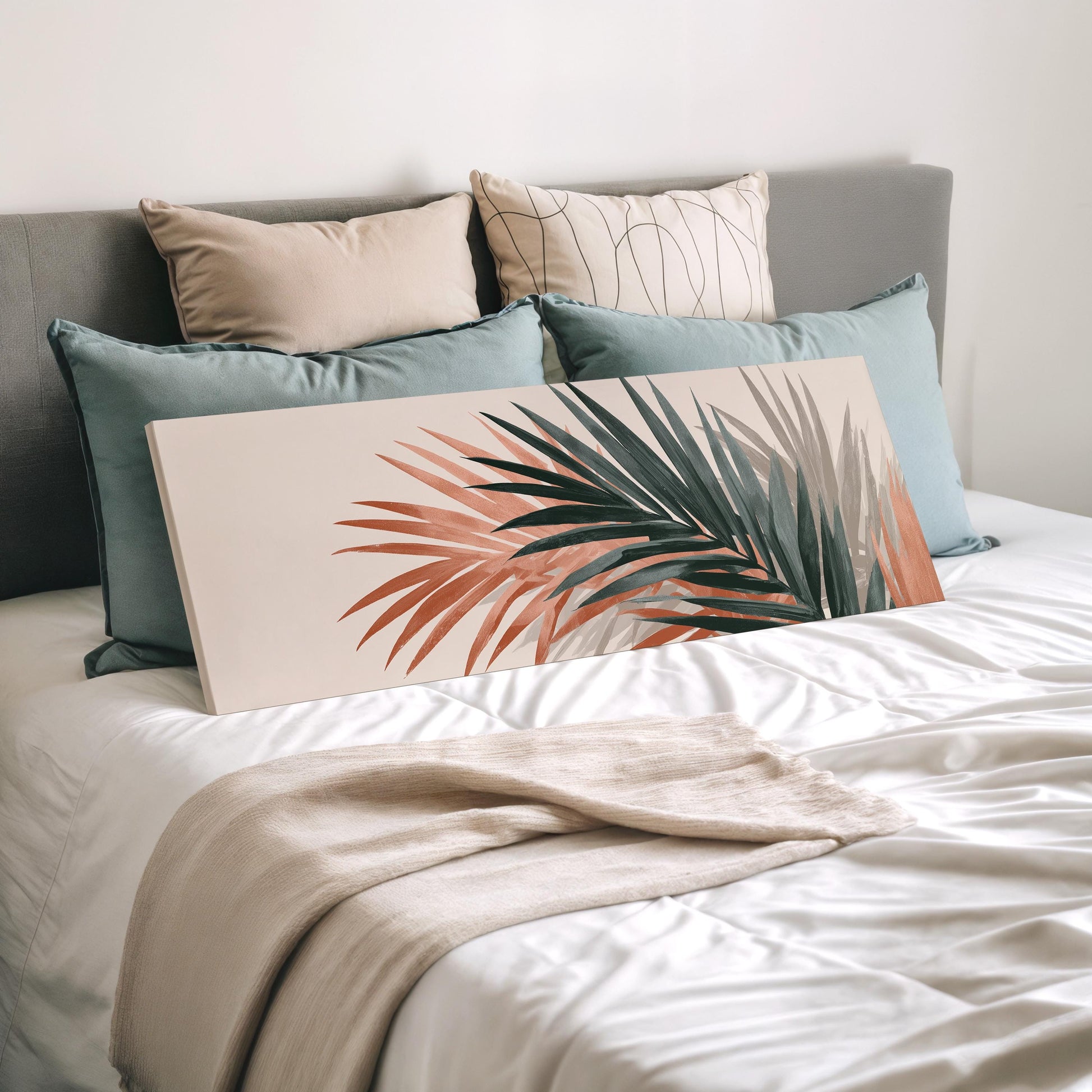 a neatly made bed with a white comforter and a large, colorful print of a palm leaf on the bed.