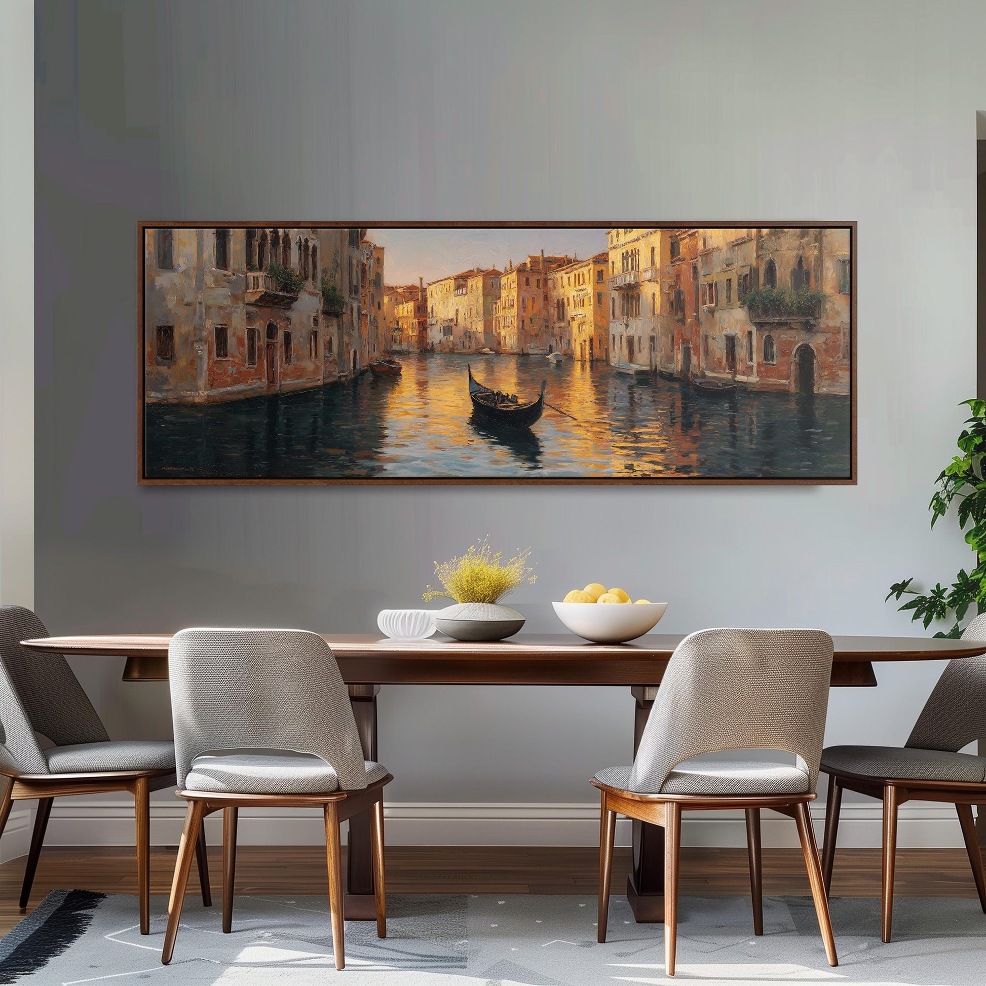 a large painting of a gondola on a canal, hanging on a wall above a wooden dining table with four chairs.