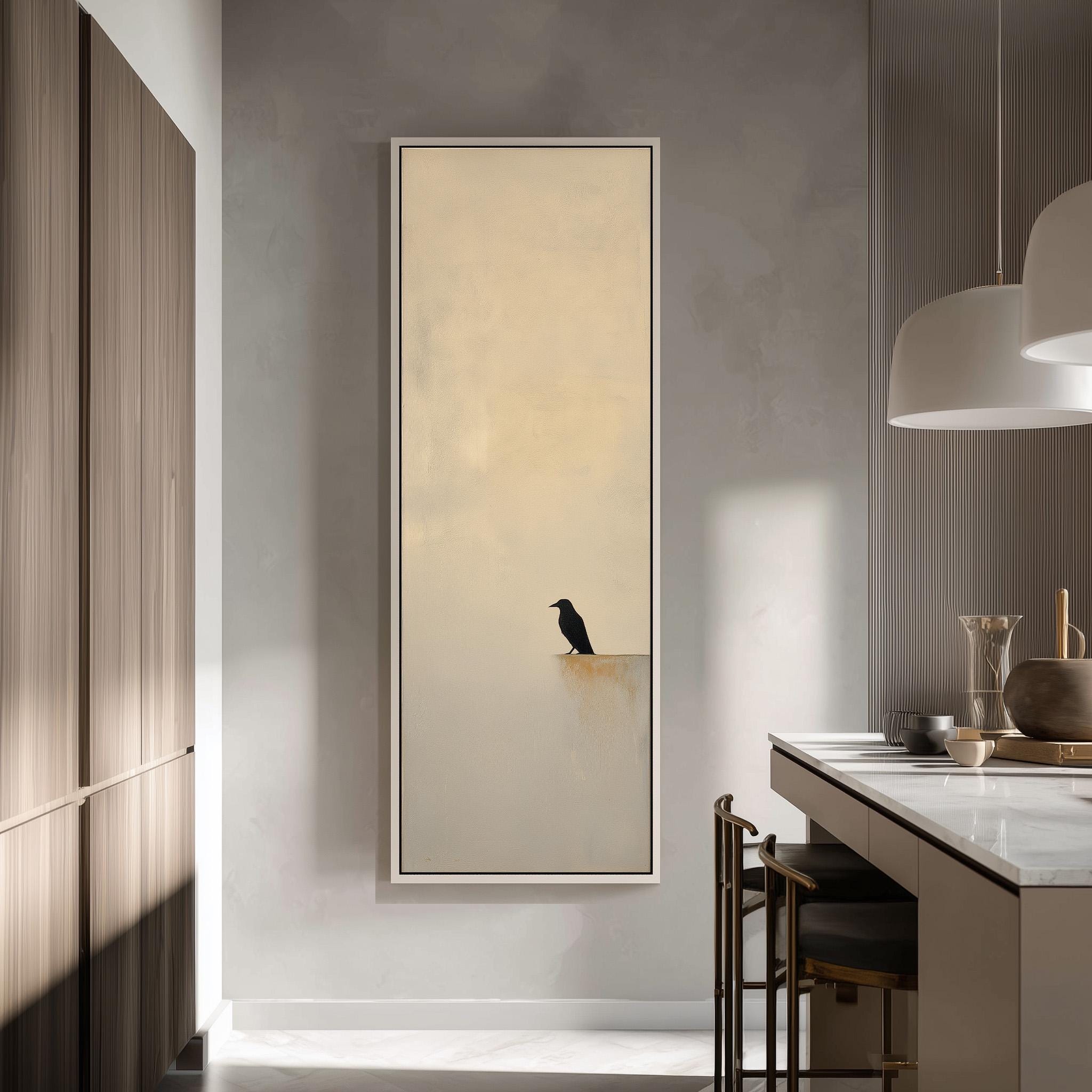 a large, framed painting of a black bird perched on a ledge, set against a light beige background. The painting is hanging on a wall in a modern, minimalist kitchen with a countertop and a pendant light above it.