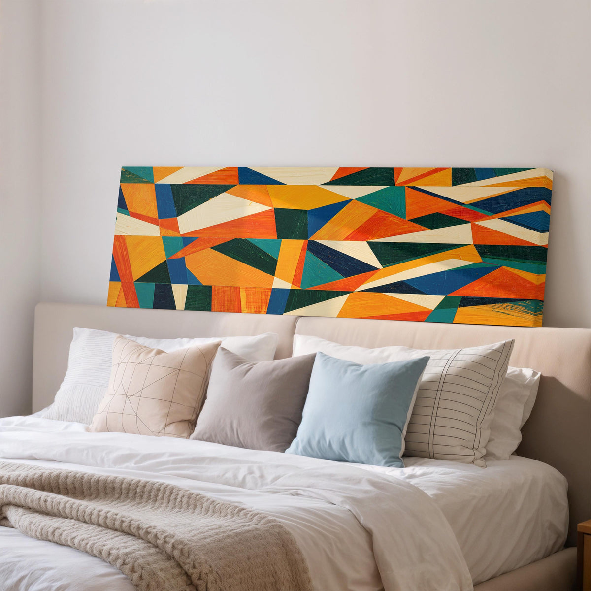Orange and teal triangle mosaic wide panoramic canvas print above a bed in a bedroom