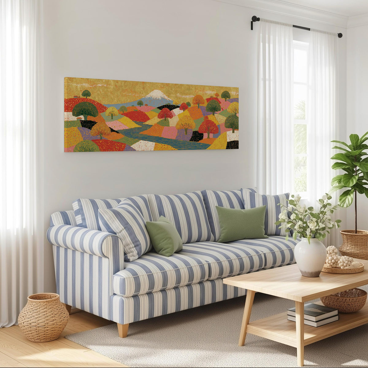 Mount Fuji over golden patchwork hills long horizontal canvas print above a striped sofa in a coastal living room