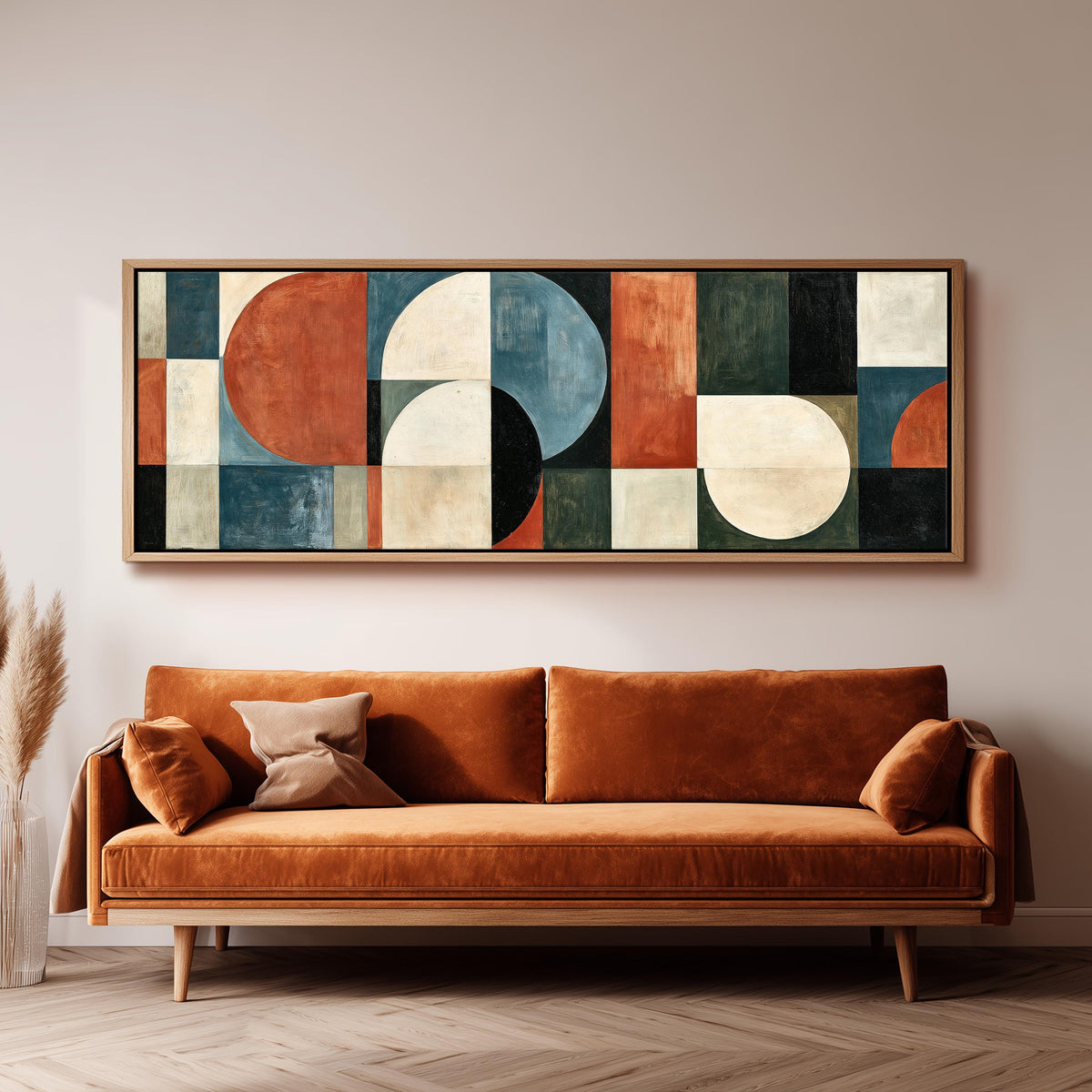 Rust and blue geometric arches and circles long horizontal canvas print above a sofa in a living room