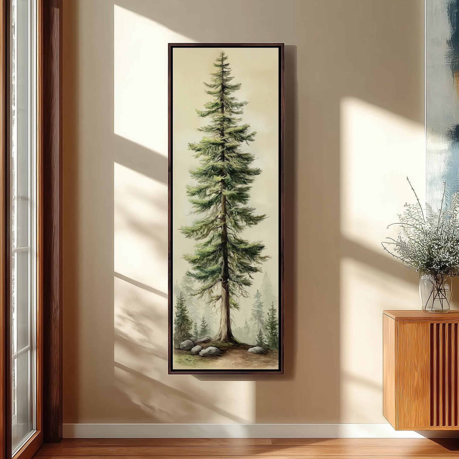 a tall, lush green pine tree with a brown trunk, standing in a natural setting with rocks and trees in the background.