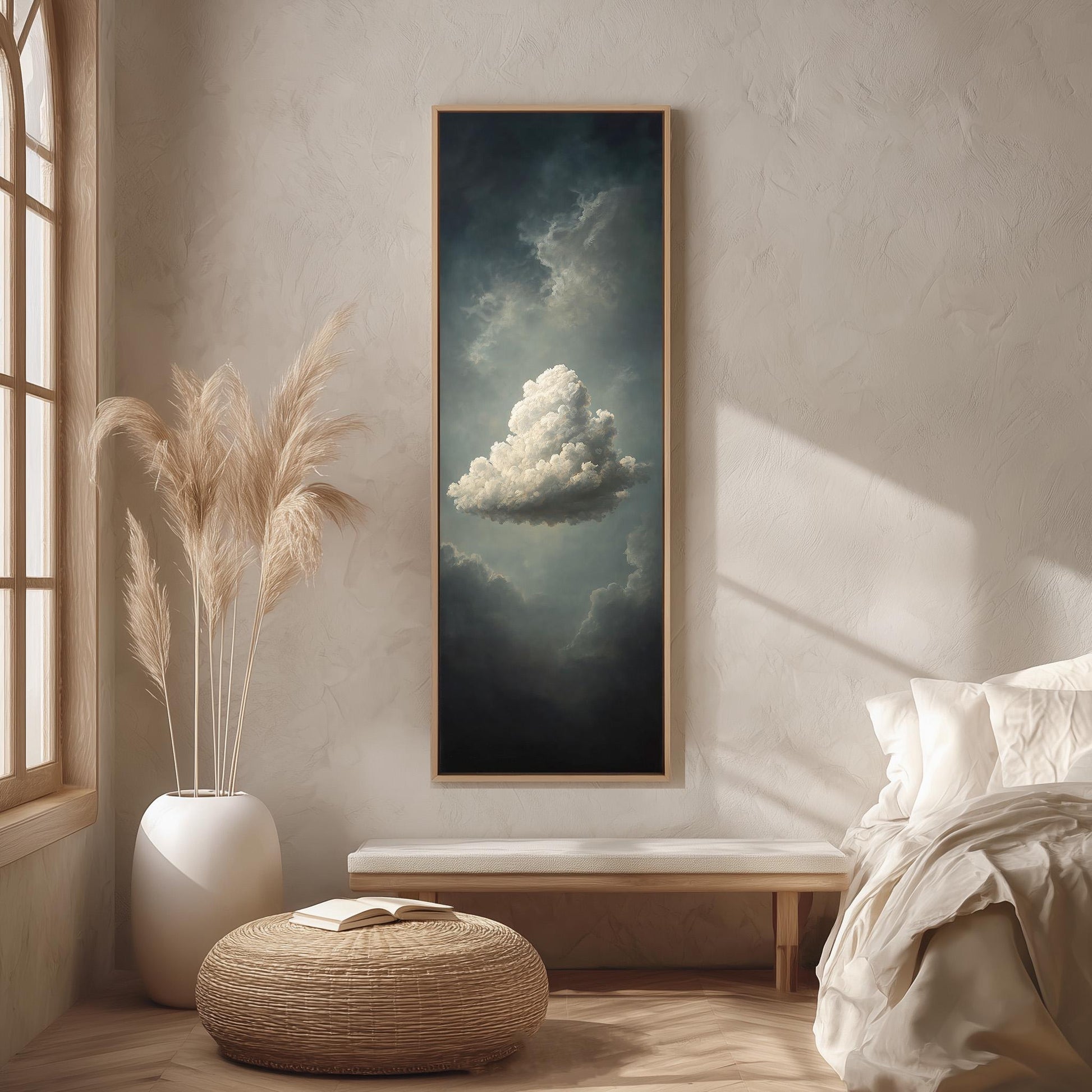 a serene bedroom scene with a large painting of a cloud hanging on the wall, a white bed with a white pillow, a white vase with tall potted plants, and a woven ottoman with a book on it.