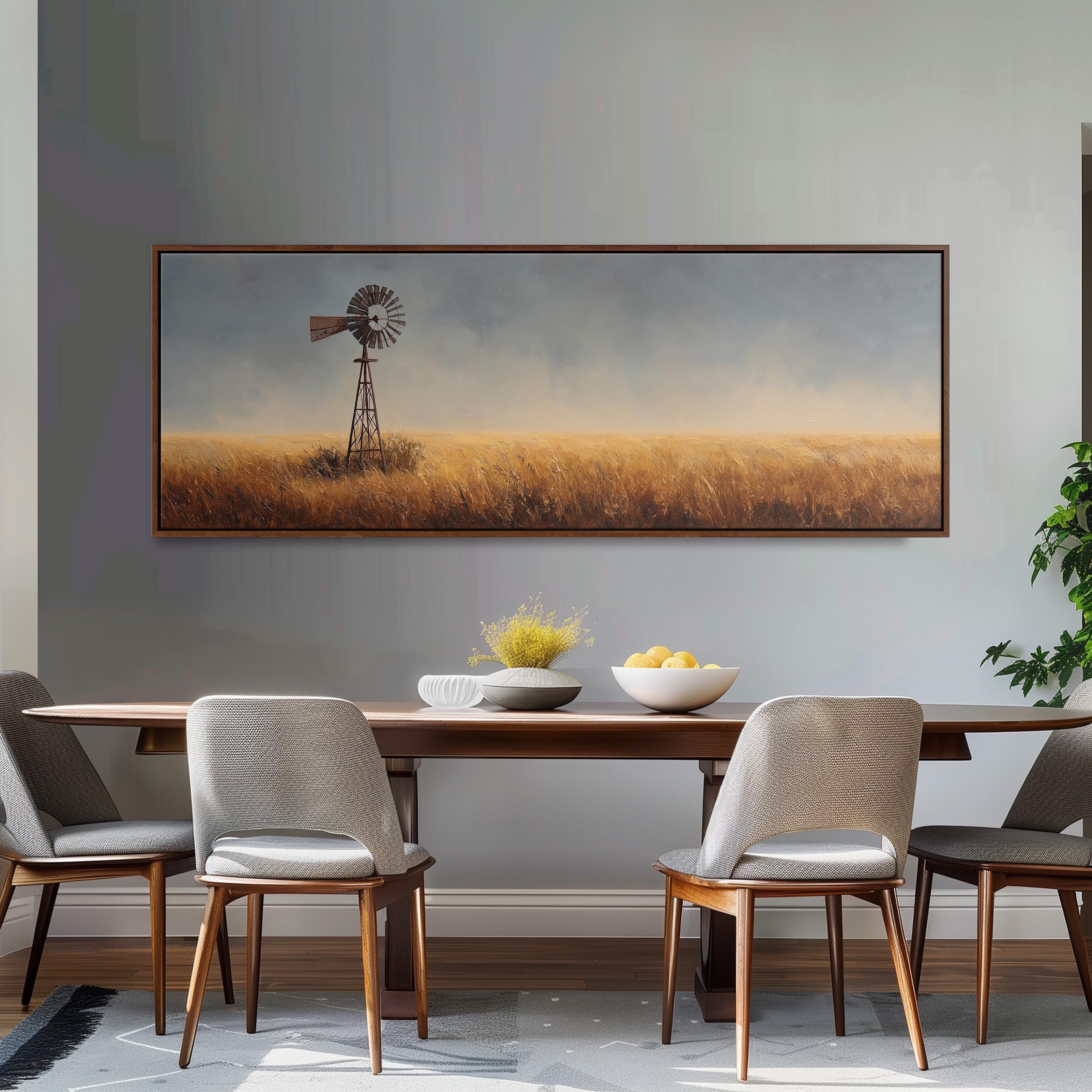a dining room with a large painting of a windmill in the background, a wooden table with chairs, and a bowl of fruit on the table.