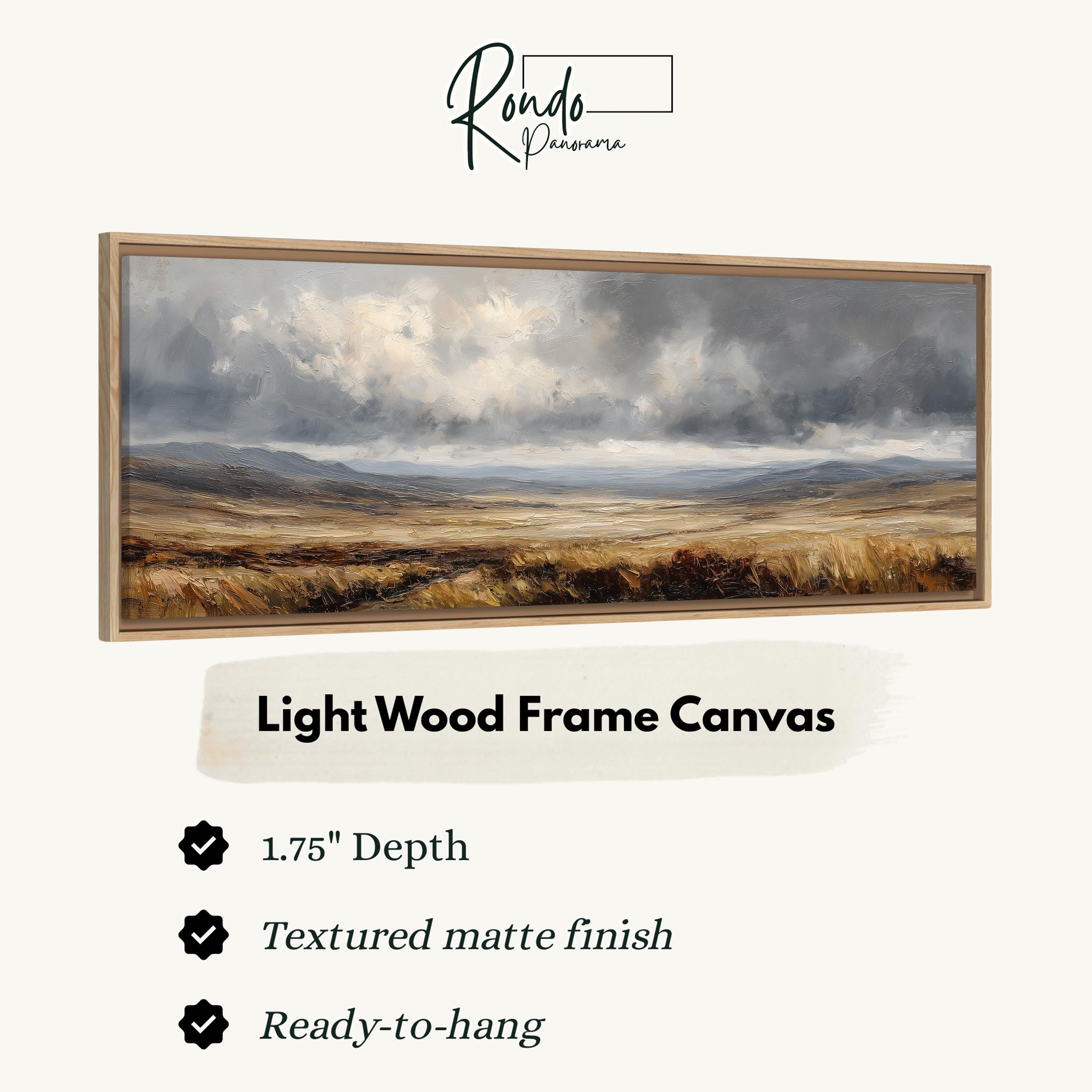 The image is a light wood frame canvas depicting a landscape with a cloudy sky and a field of grass.
