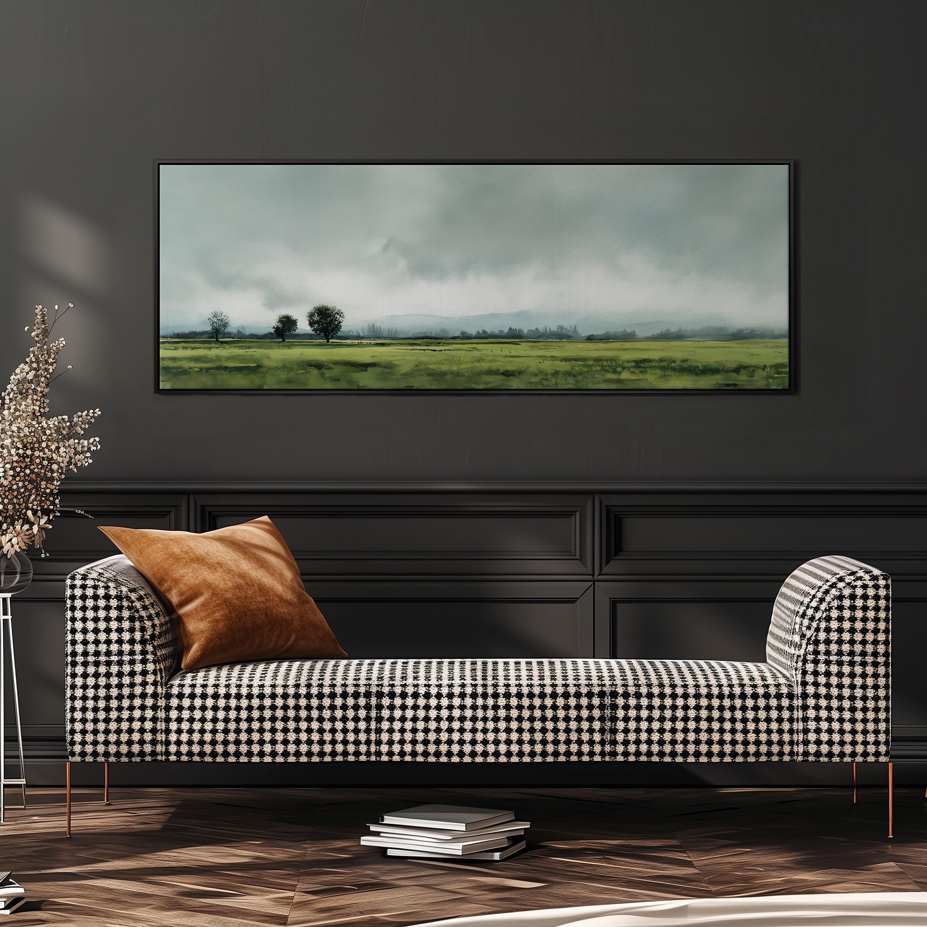 a black and white checkered sofa with a brown throw pillow, positioned in front of a large framed landscape painting on a dark wall.