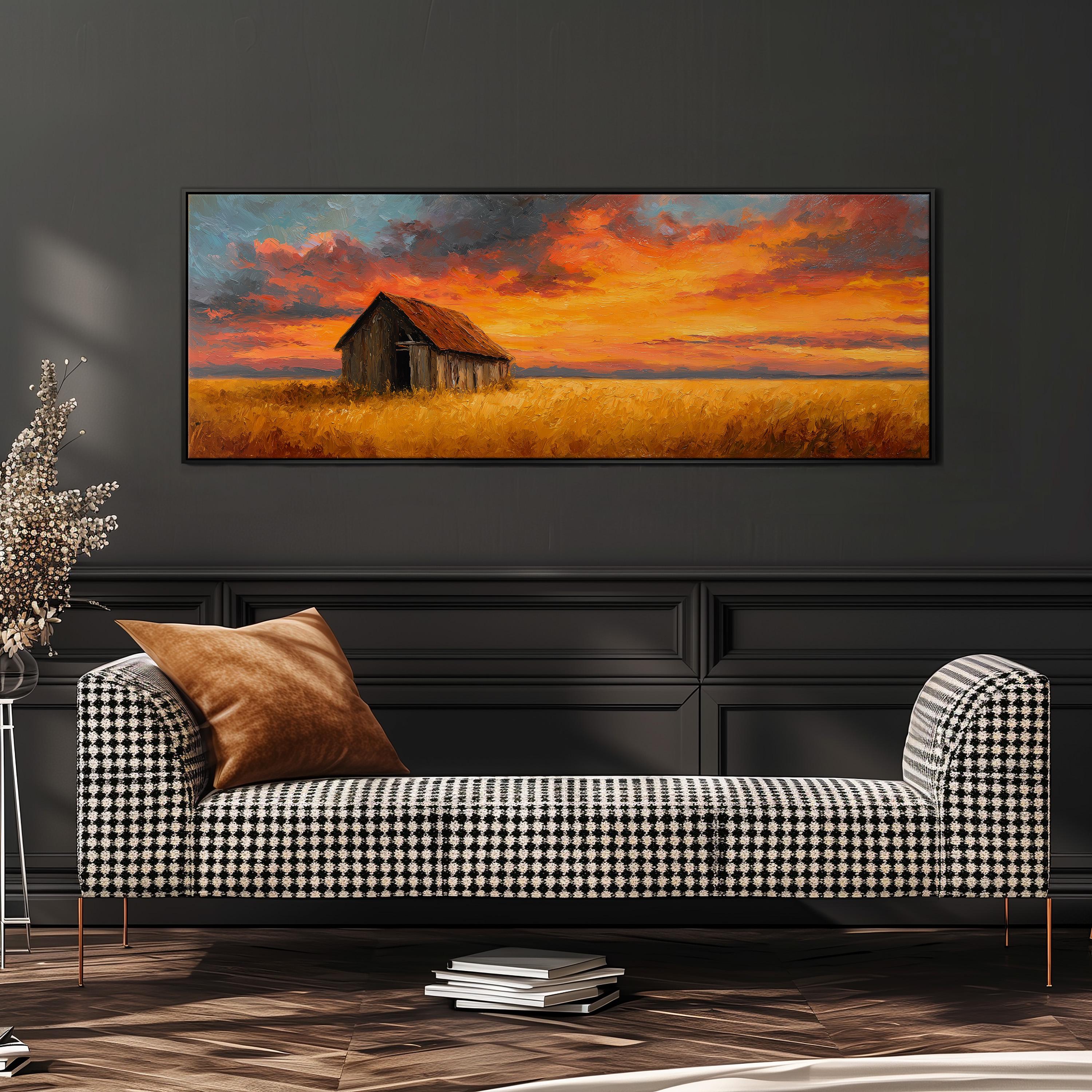 a large painting of a barn and a field with a colorful sunset sky above it, hanging on a wall above a black and white checkered sofa.