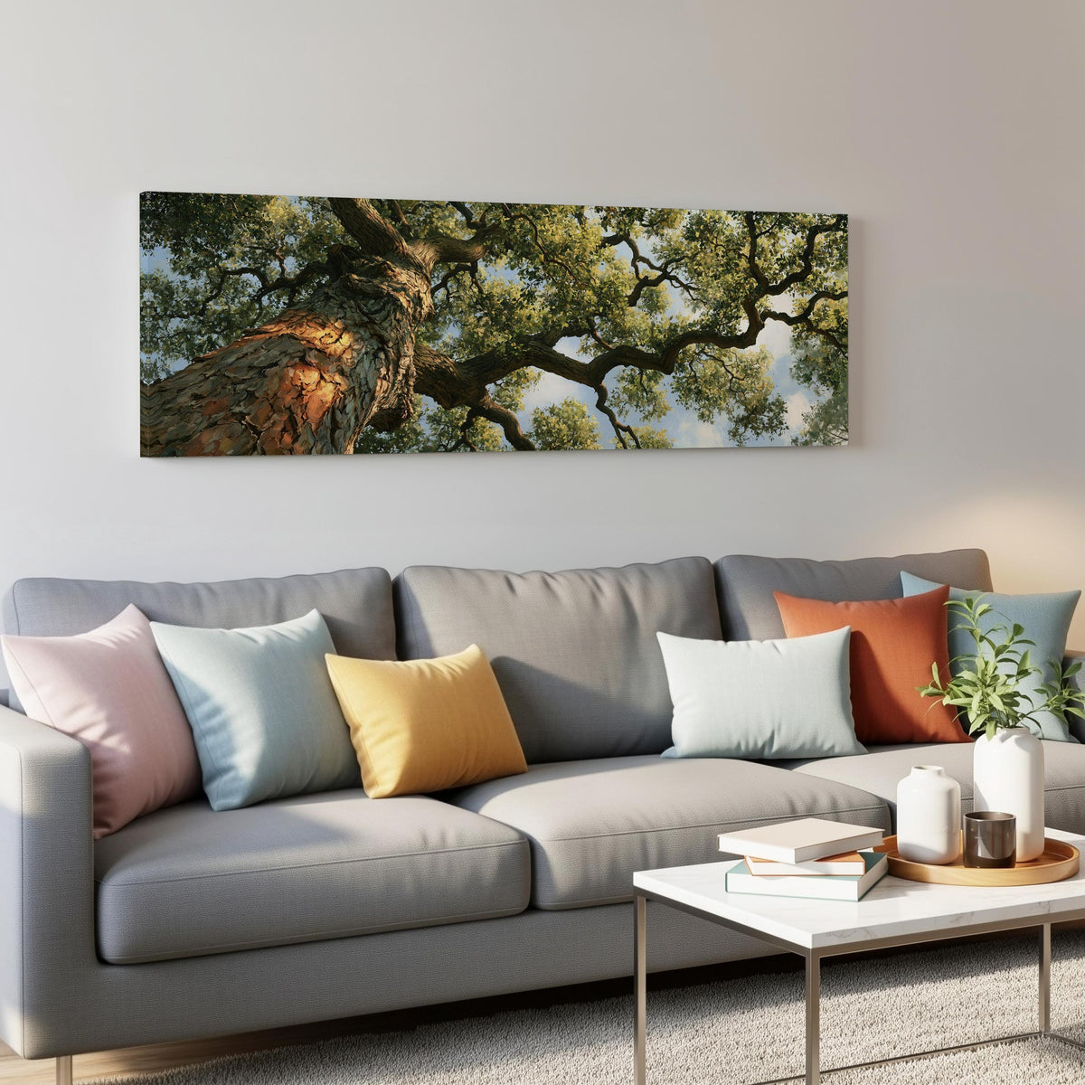 Ancient oak trunk and branches seen from below panoramic canvas print above a grey sofa in a living room