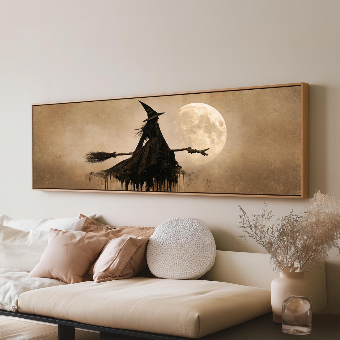 Witch flying past a sepia moon long horizontal canvas print above a sofa in a living room