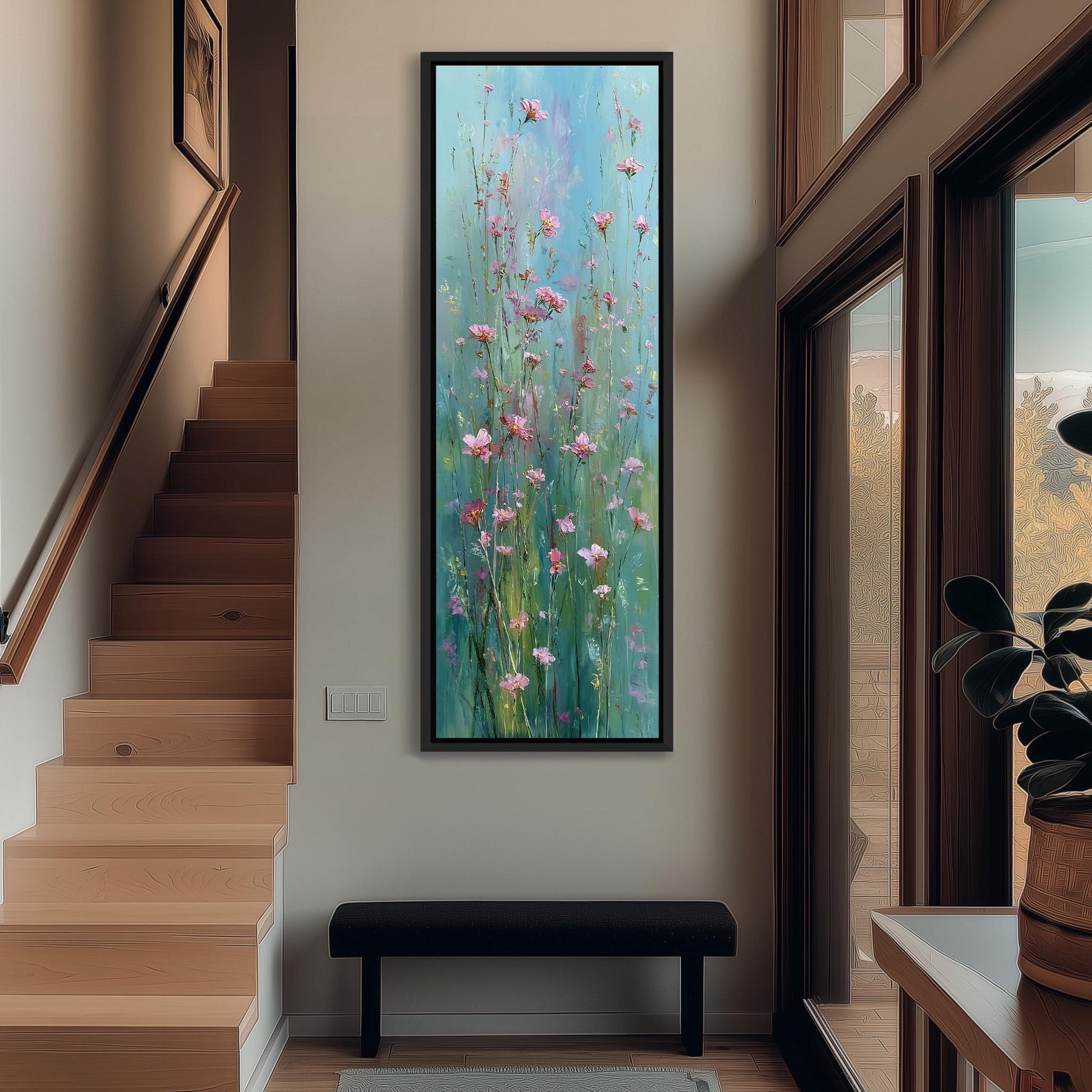 a large painting of pink flowers hanging on a wall in a hallway. The painting is framed and appears to be the focal point of the space. The hallway has a wooden staircase and a bench, creating a cozy and inviting atmosphere.