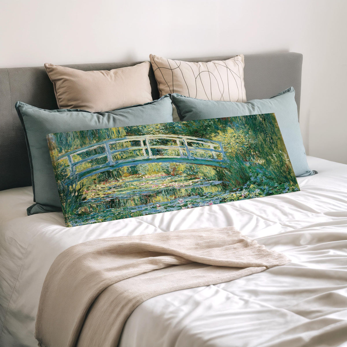 Japanese bridge over a water lily pond wide panoramic canvas print laid on a bed to show its size