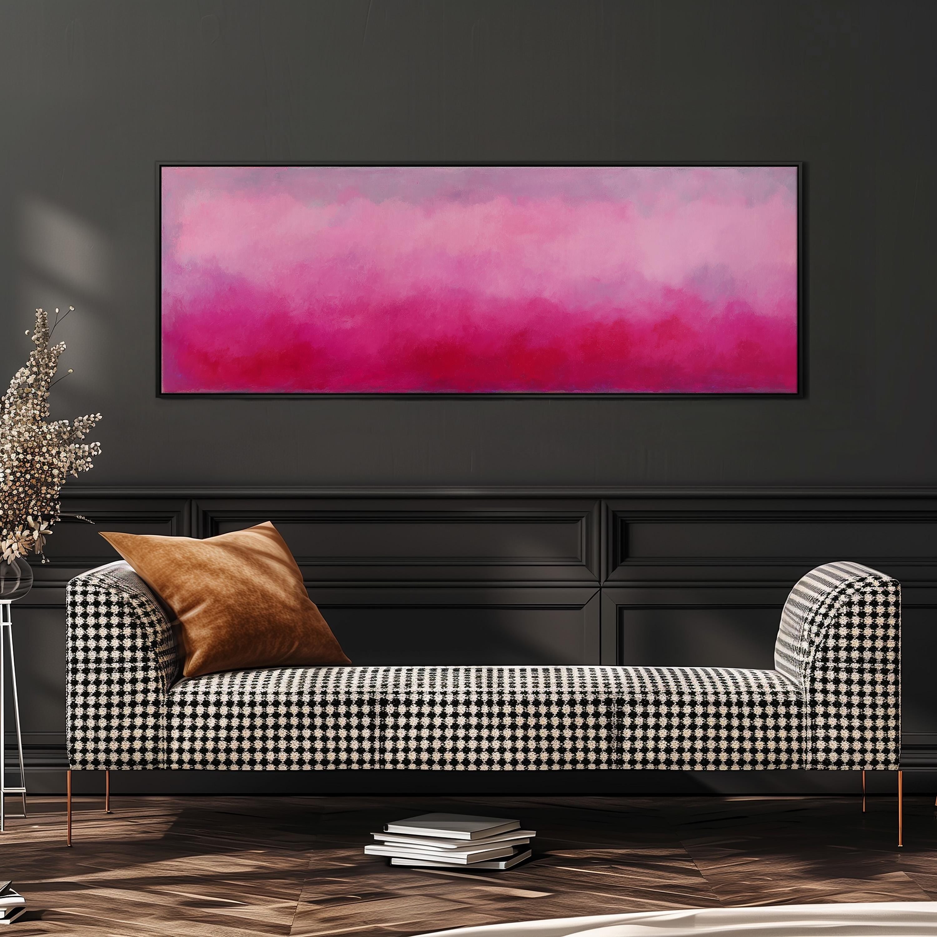 a modern living room with a black and white checkered sofa, a large abstract painting in pink and purple colors hanging on the wall, and a stack of books on the floor.