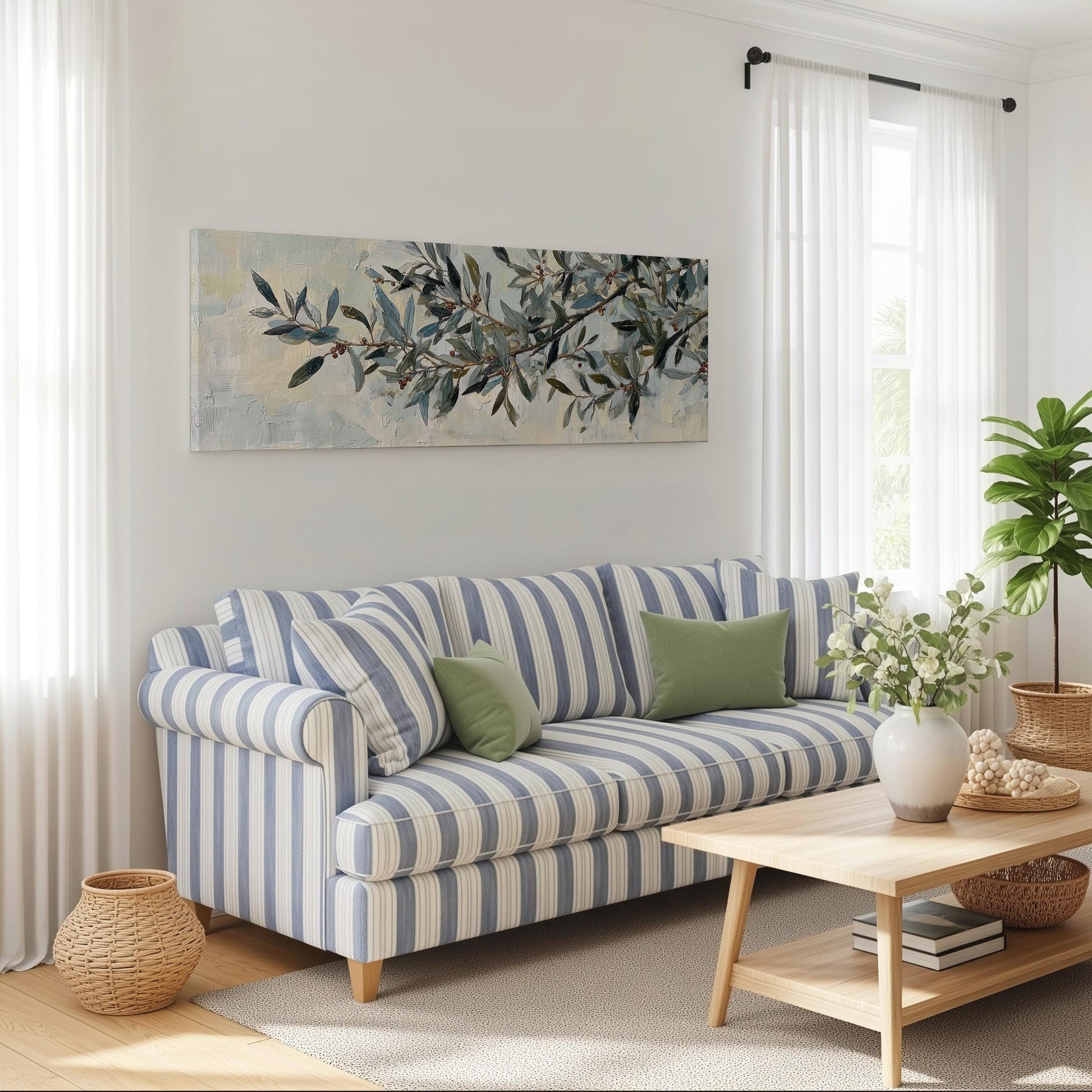 a cozy living room with a striped blue and white sofa, a wooden coffee table, and a large painting of leaves on the wall.