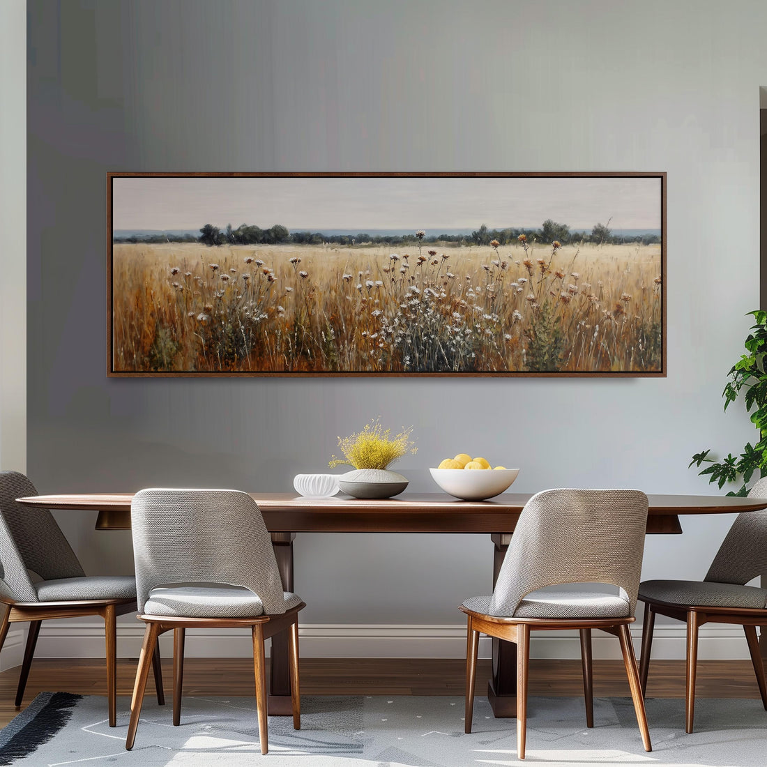 a dining room with a large painting of a field of flowers hanging on the wall above a wooden dining table with four chairs. The table is set with a bowl of fruit and a vase of flowers, creating a cozy and inviting atmosphere.