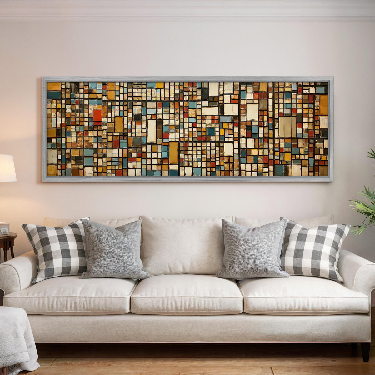 Ochre and blue mosaic tiles with red accents panoramic canvas print above a white sofa in a bright living room
