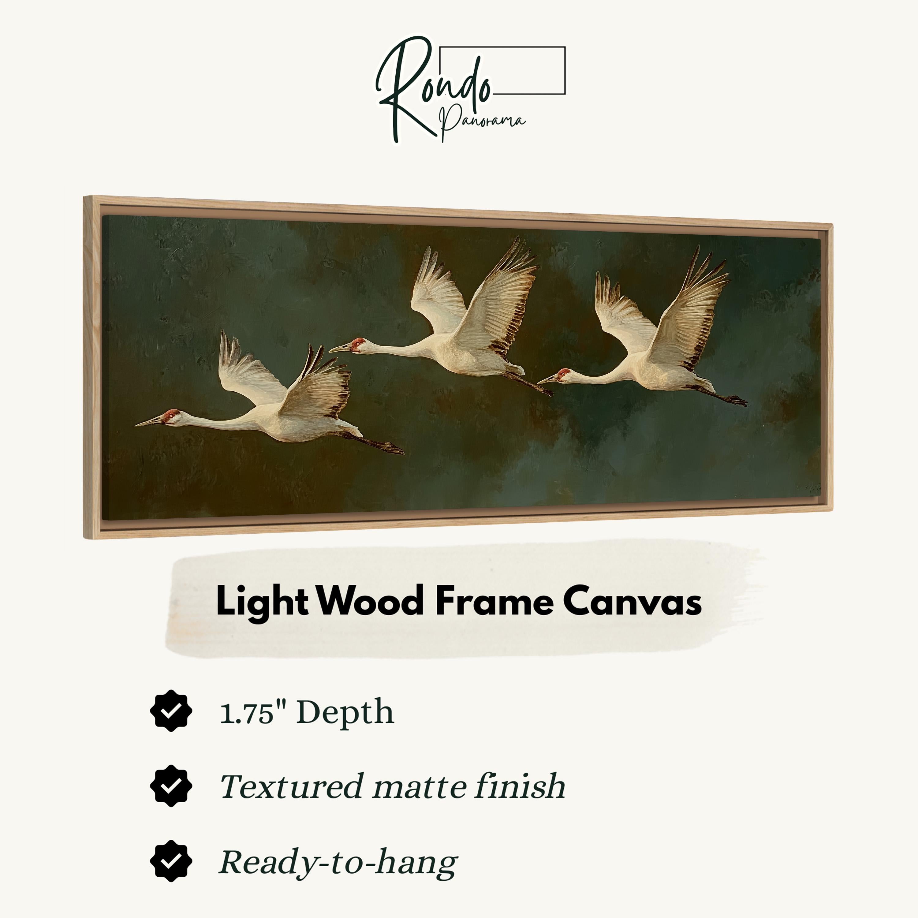 a light wood frame canvas depicting three white birds in flight.