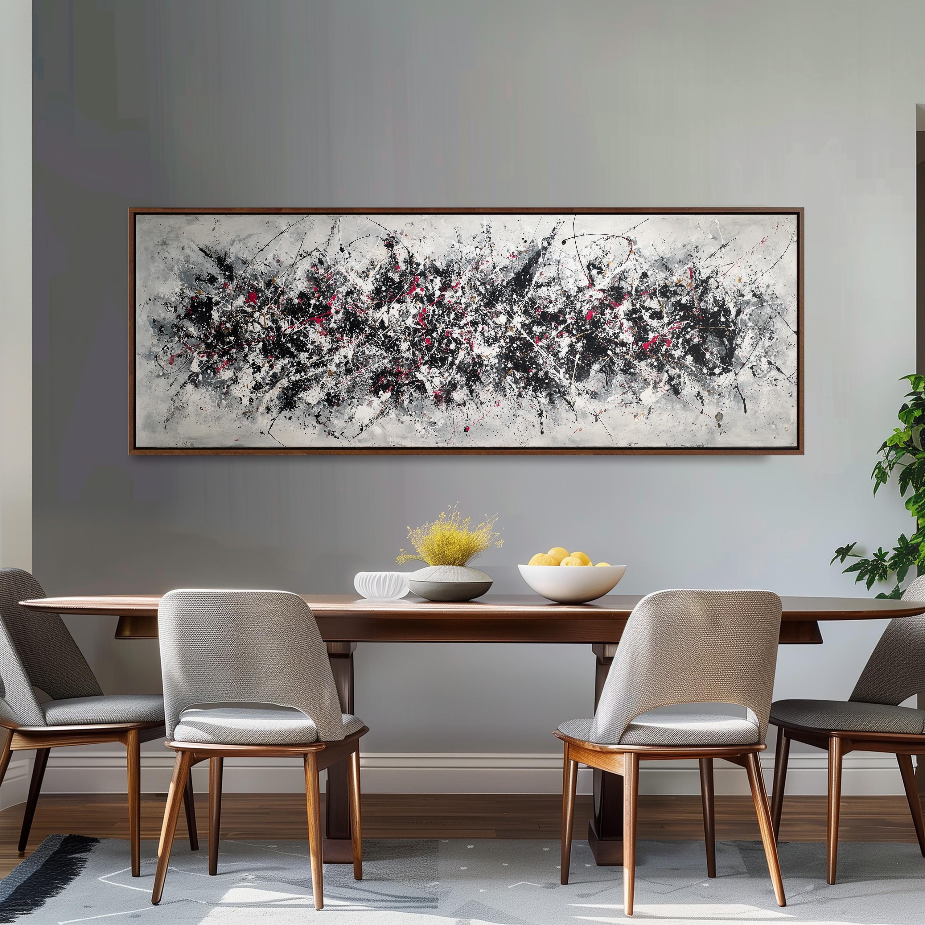 a dining room with a large abstract painting hanging on the wall above a wooden dining table with four chairs. The table is set with a bowl of fruit and a vase of flowers, creating a cozy and inviting atmosphere.