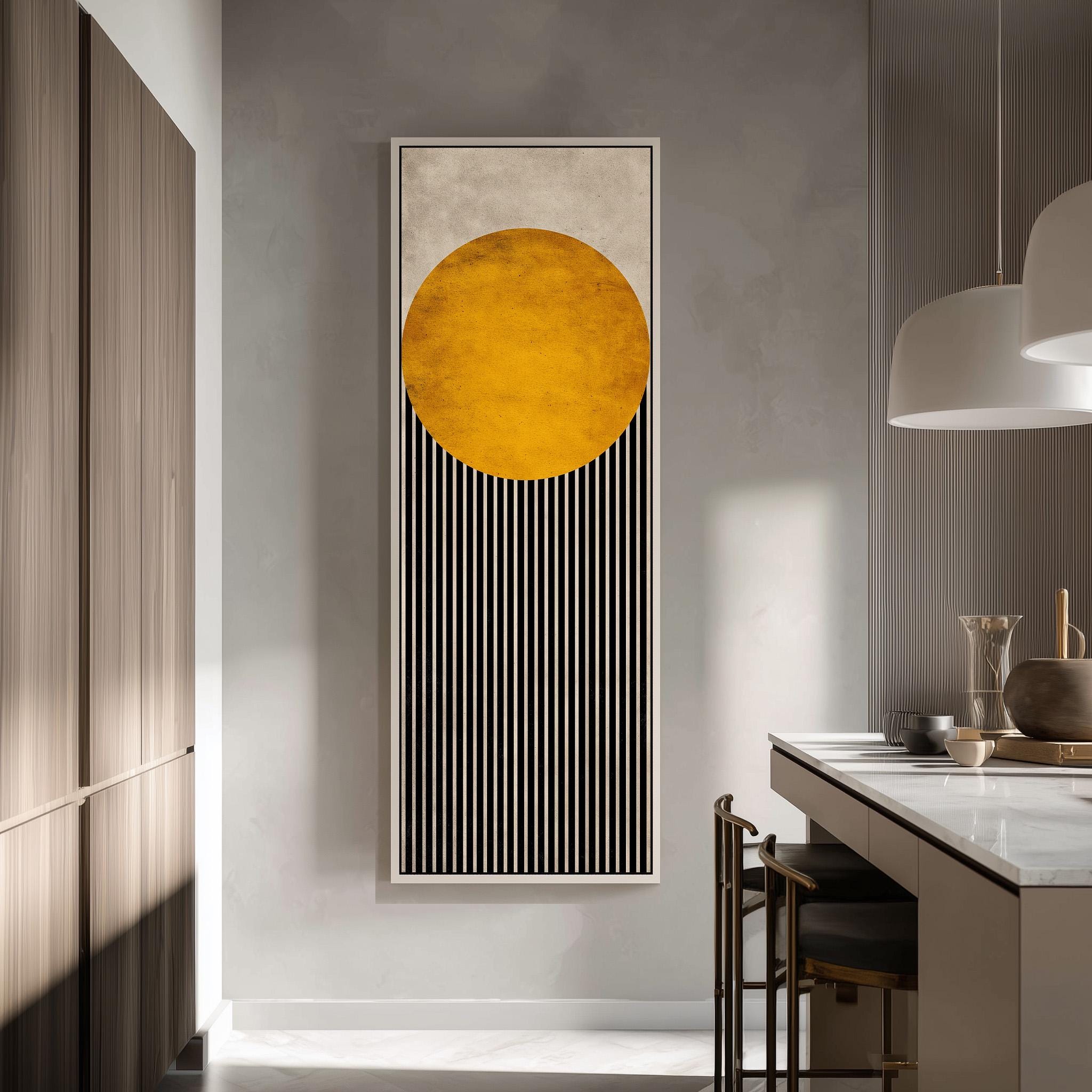 a modern kitchen with a large abstract painting hanging on the wall. The painting consists of a large circle with vertical stripes, creating a striking visual contrast. The kitchen is well-lit, with a countertop and chairs visible, and a pendant light hanging above the countertop.