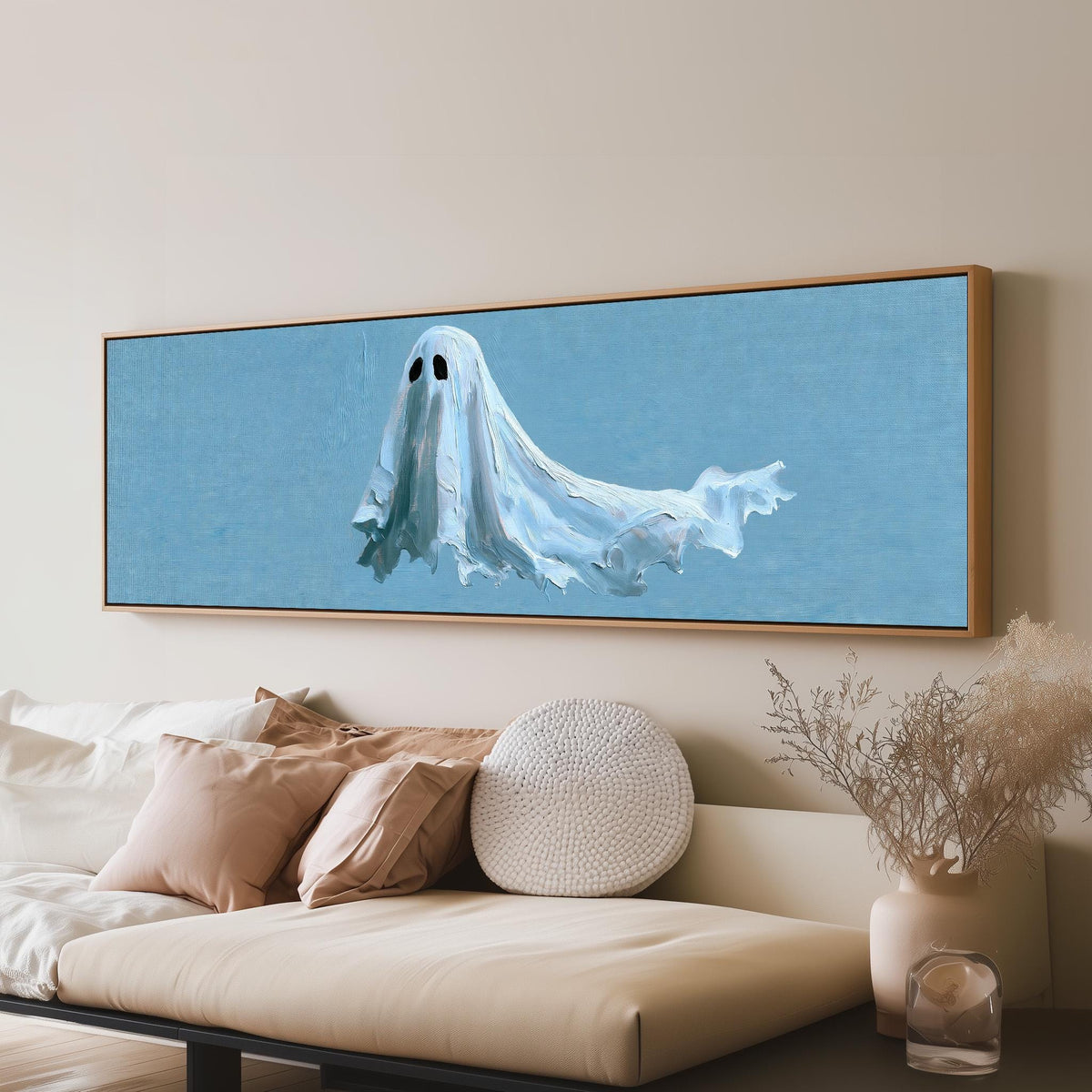 Floating ghost on blue panoramic canvas print above a sofa in a living room