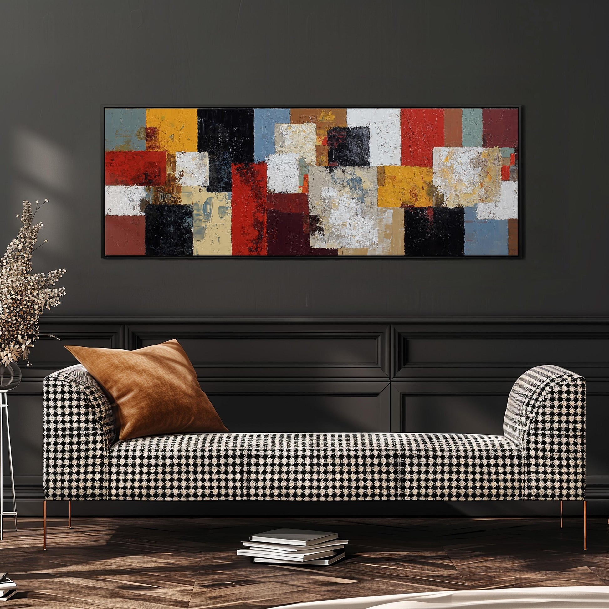 a modern living room with a black and white checkered sofa, a stack of books, and a large abstract painting hanging on the wall above the sofa.