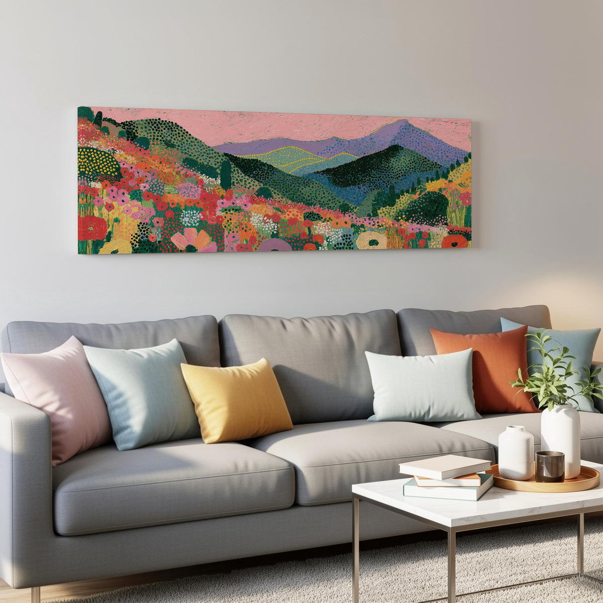 Purple mountains over a flower meadow panoramic canvas print above a grey sofa in a living room