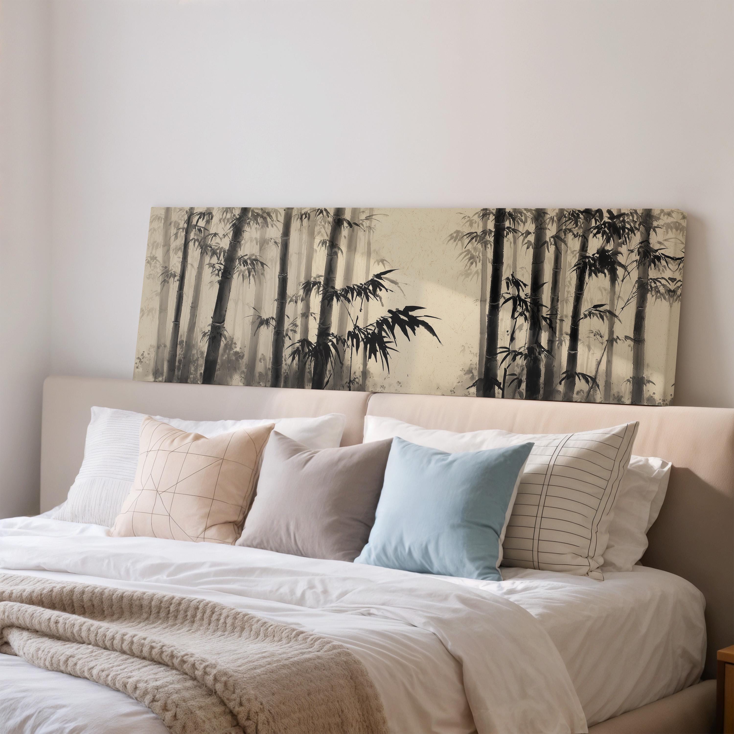 a large bed with a white comforter and pillows, and a large wall art print depicting a bamboo forest.
