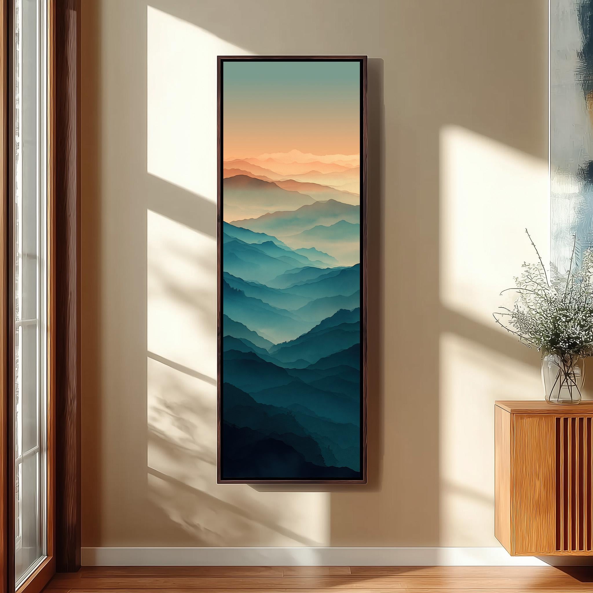 a large, framed painting of a mountainous landscape hanging on a wall in a room with a wooden floor and a window.