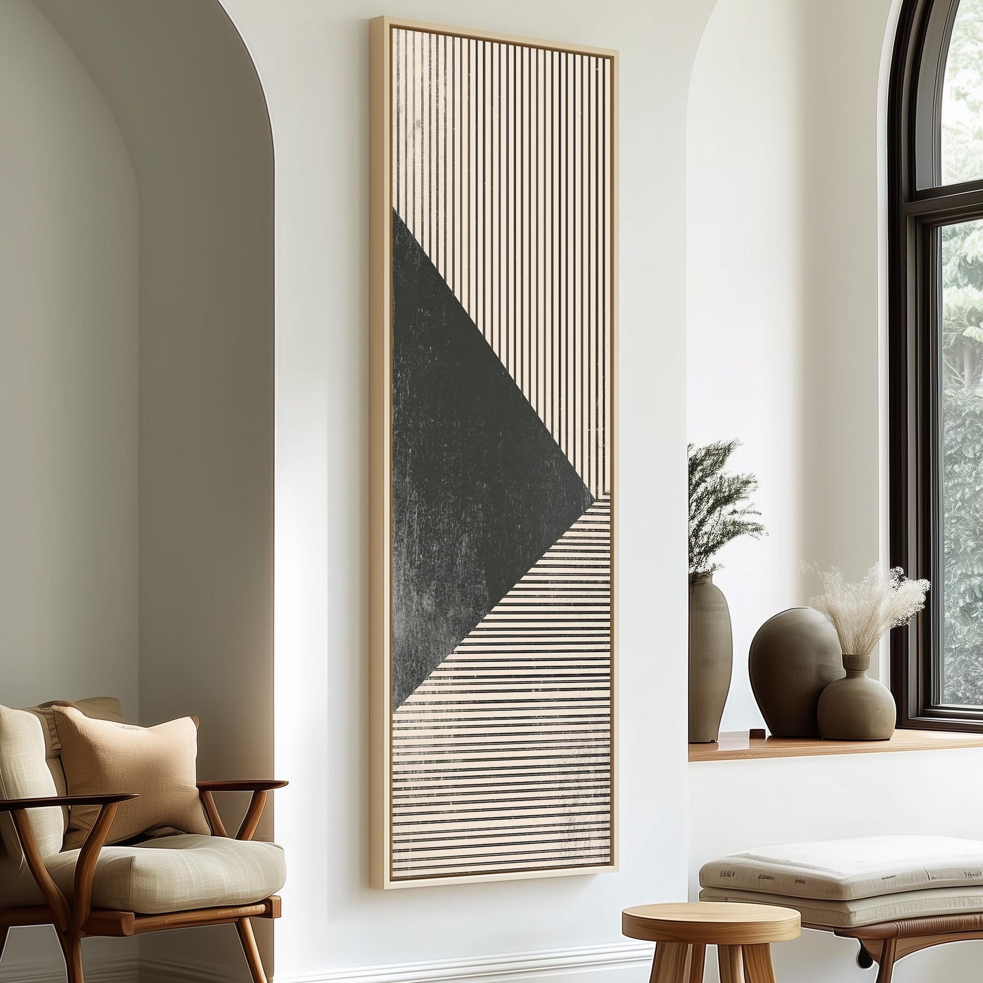 a modern living room with a large abstract painting on the wall, a wooden chair, a small table, and a window with a plant on the sill.