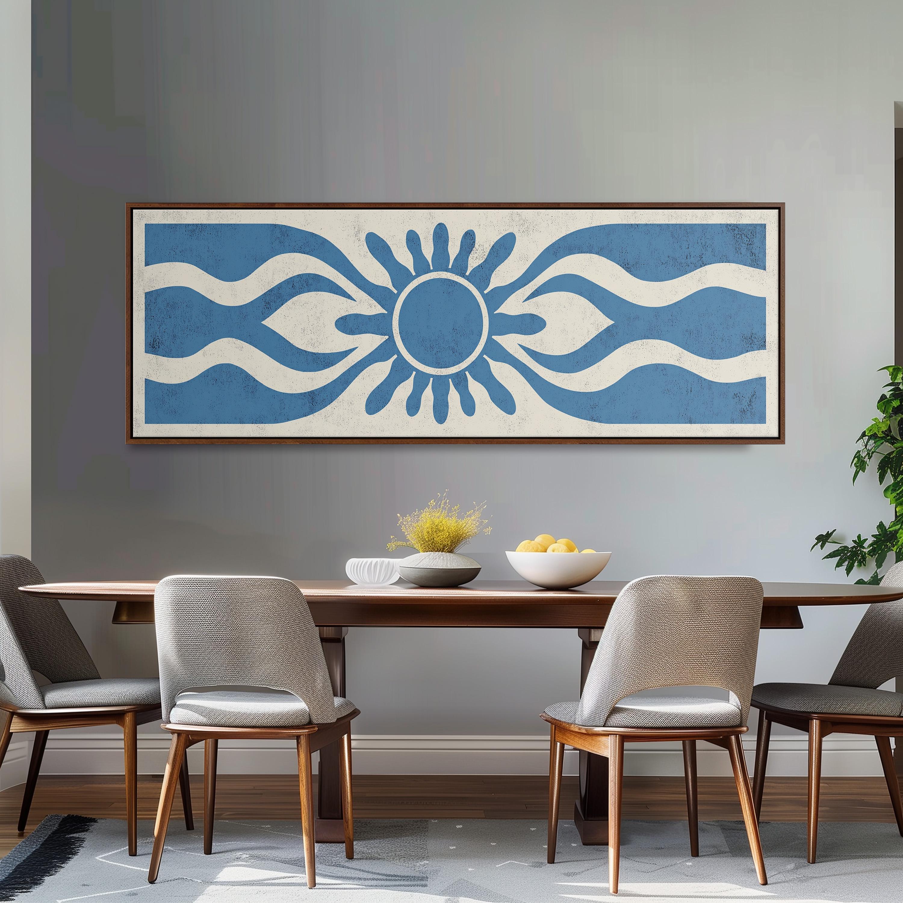 a dining room with a wooden table and four chairs. Above the table, there is a large blue and white abstract artwork hanging on the wall. The table is set with a bowl of fruit and a vase of flowers, creating a welcoming and cozy atmosphere.