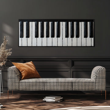 a black and white checkered sofa with a brown throw pillow, placed against a dark wall with a large black and white piano keyboard painting above it.