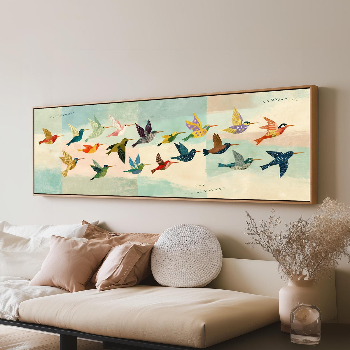 Flock of colorful hummingbirds long horizontal canvas print above a sofa in a living room