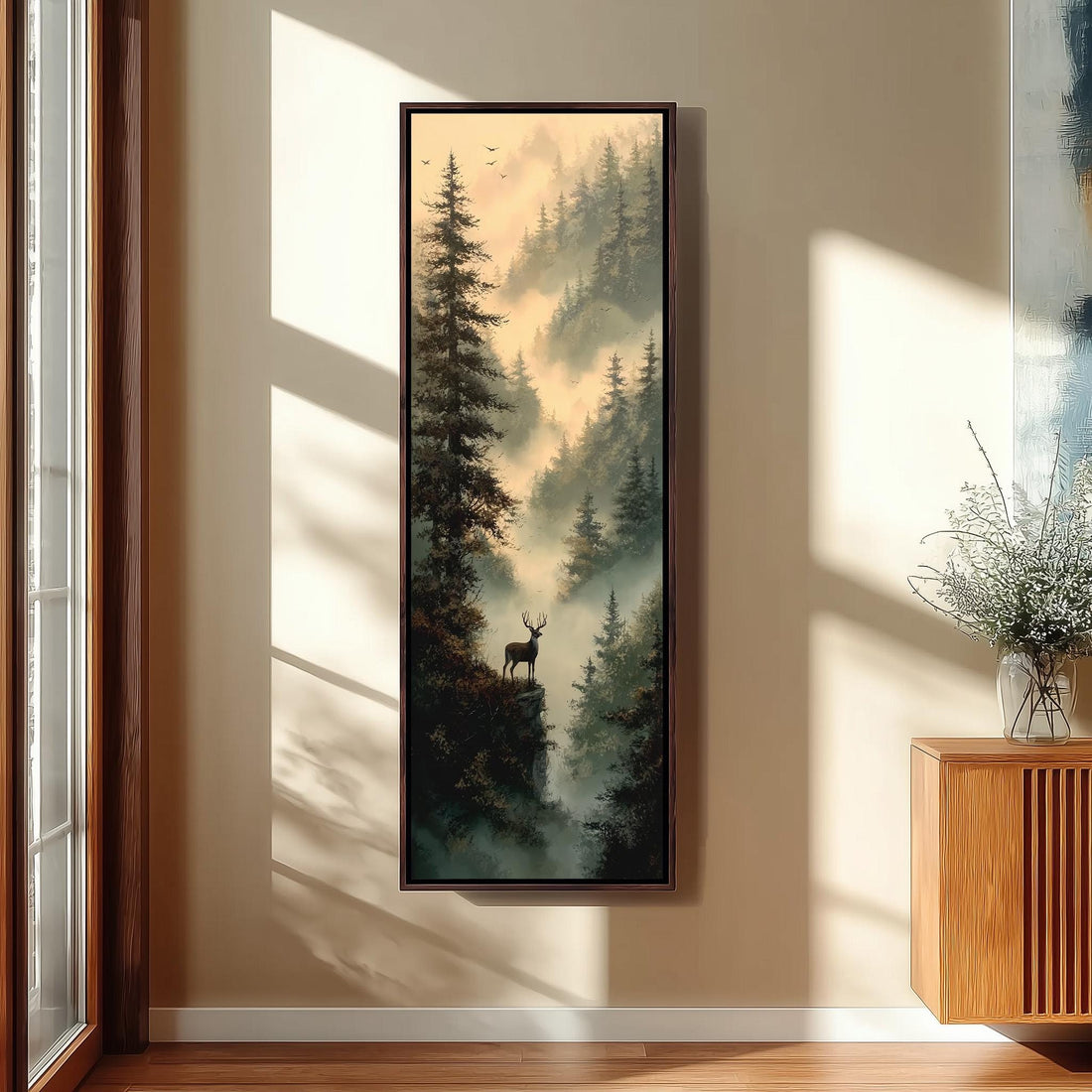 a hallway with a large painting of a deer standing on a cliff overlooking a misty forest. The painting is framed and hangs on the wall above a bench. The hallway has wooden stairs leading up to the painting, and there is a plant on the right side of the image.