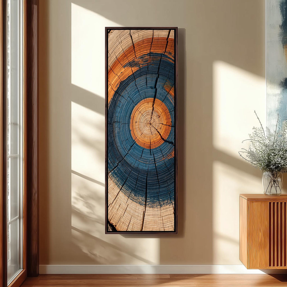 Blue and orange tree ring tall skinny canvas print in a sunlit living space