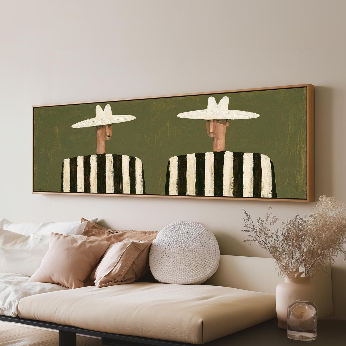 Two figures in striped shirts panoramic canvas print above a sofa in a living room