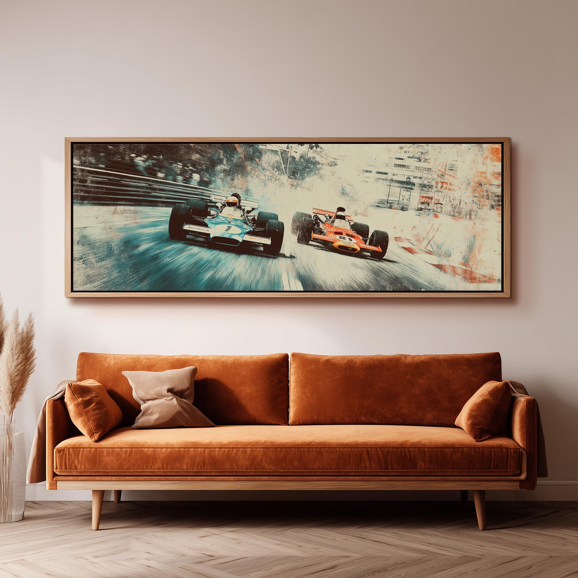 a large framed print of two Formula One race cars speeding down a track, hanging on a wall above a brown sofa.