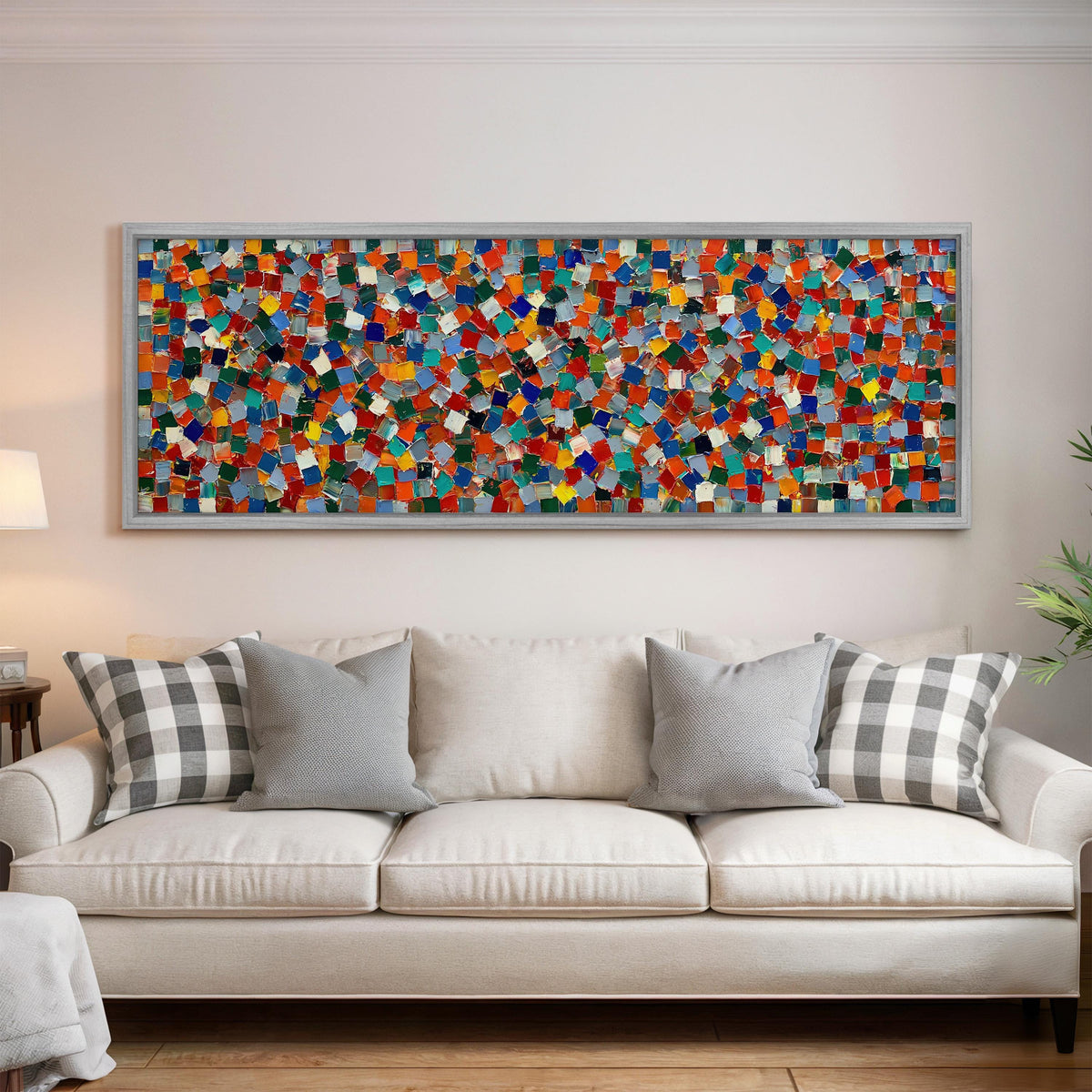 Colorful confetti mosaic squares panoramic canvas print above a white sofa in a bright living room