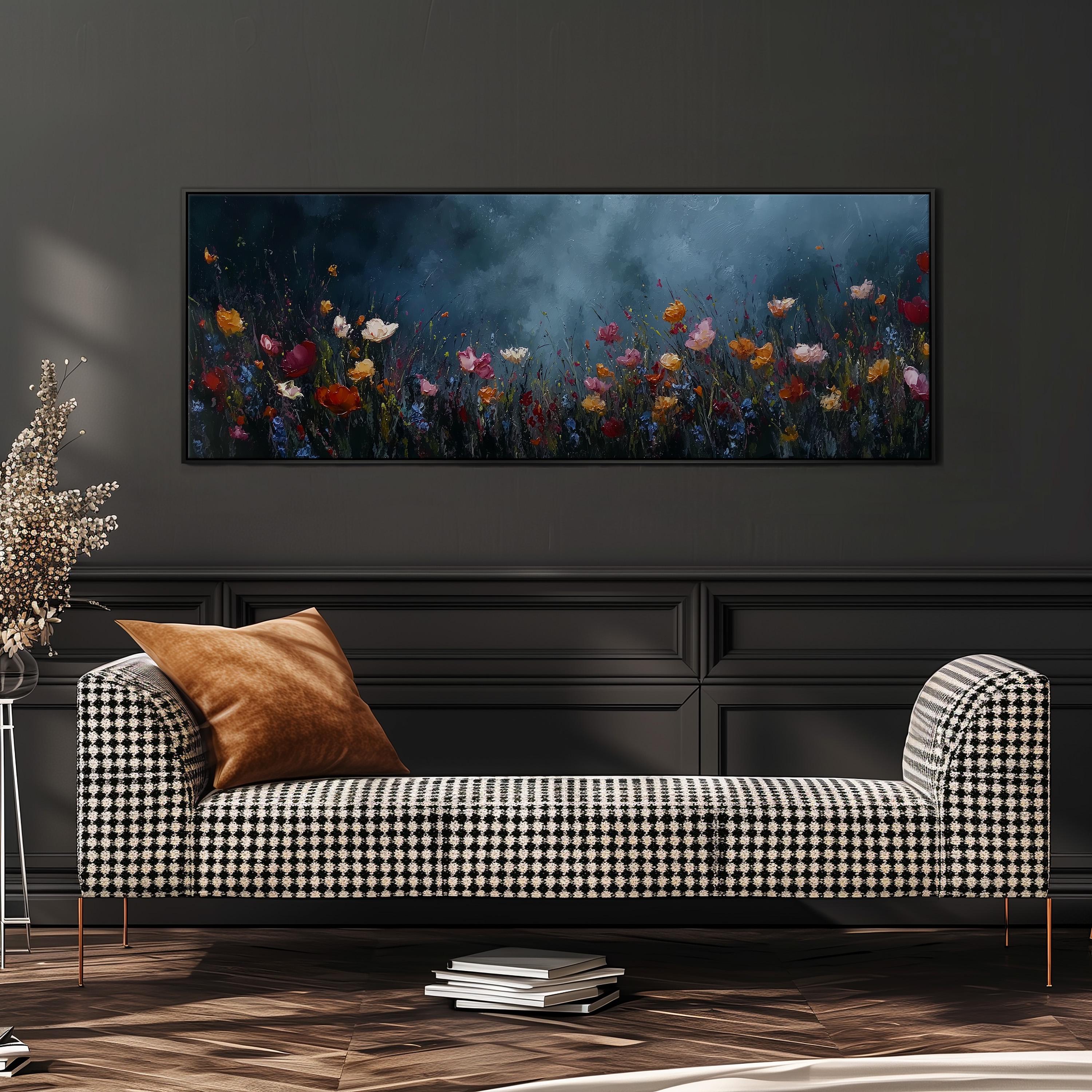 a checkered sofa with a brown throw pillow, set against a dark wall with a large framed painting of a field of colorful flowers hanging above it.