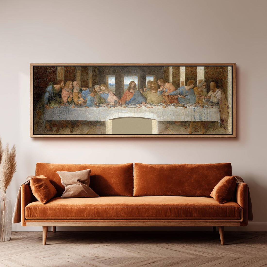 a large painting of the Last Supper hanging on a wall above a wooden dining table with four chairs.