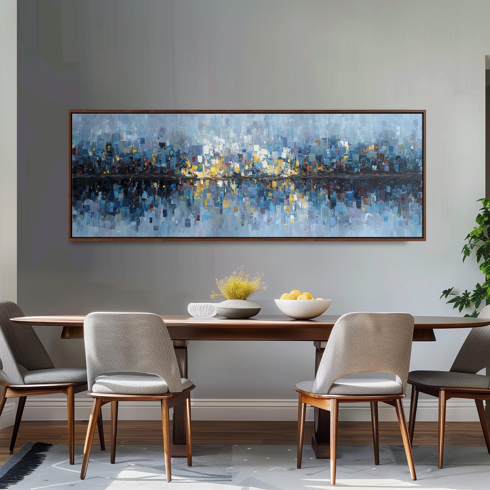 a large, colorful painting of a cityscape hanging on a wall above a wooden dining table with four chairs. The table is set with a bowl of fruit and a vase of flowers, creating a cozy and inviting atmosphere.