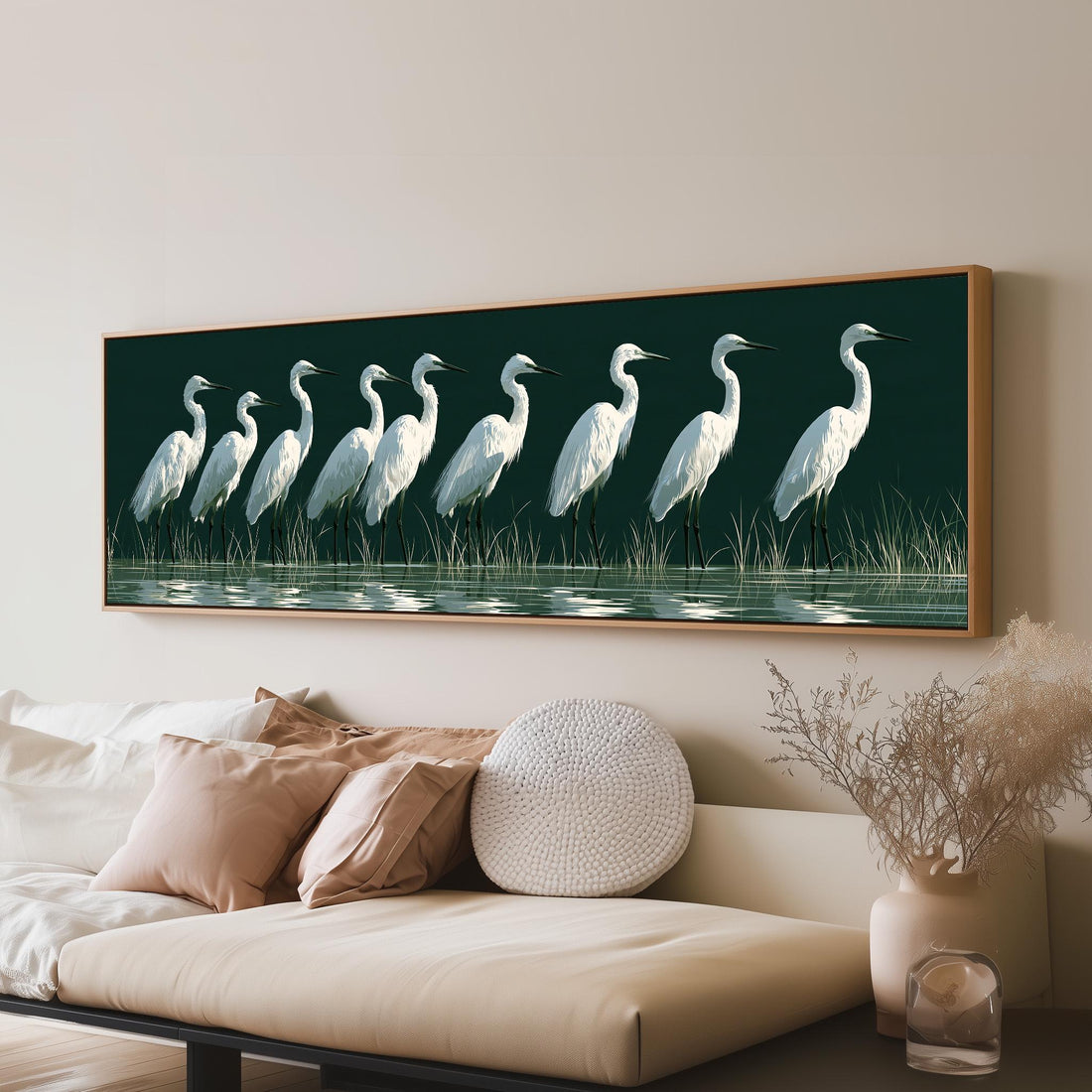 Row of white egrets on deep green long horizontal canvas print above a sofa in a living room