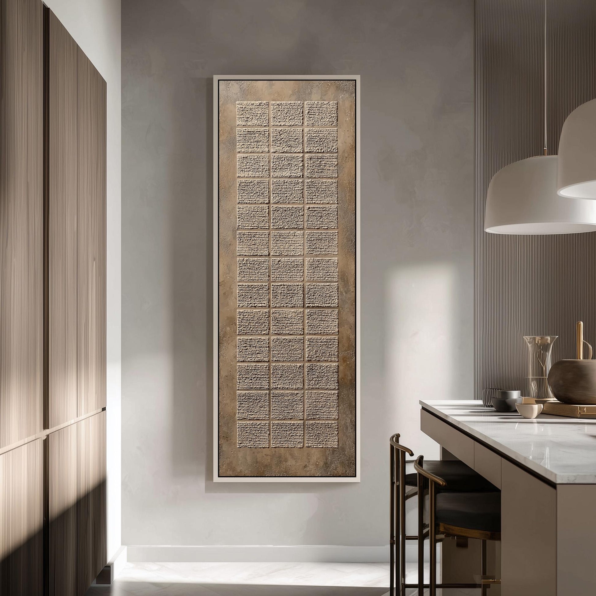 a modern kitchen with a large, rectangular wall art piece hanging above the counter. The kitchen has a minimalist design with a white countertop, wooden cabinets, and a pendant light above the counter.
