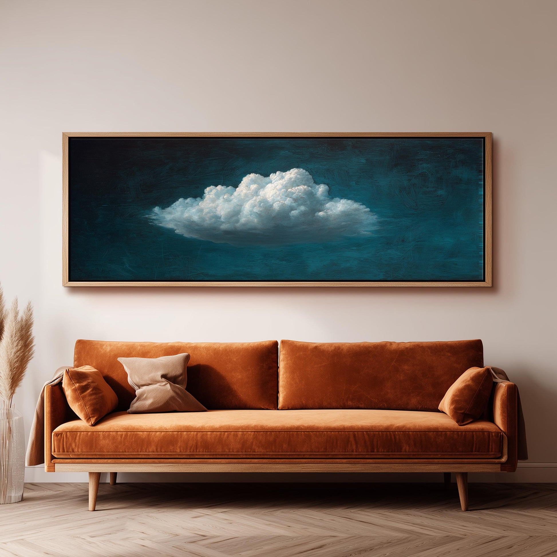 a large, framed painting of a cloud hanging on a wall above a brown sofa.