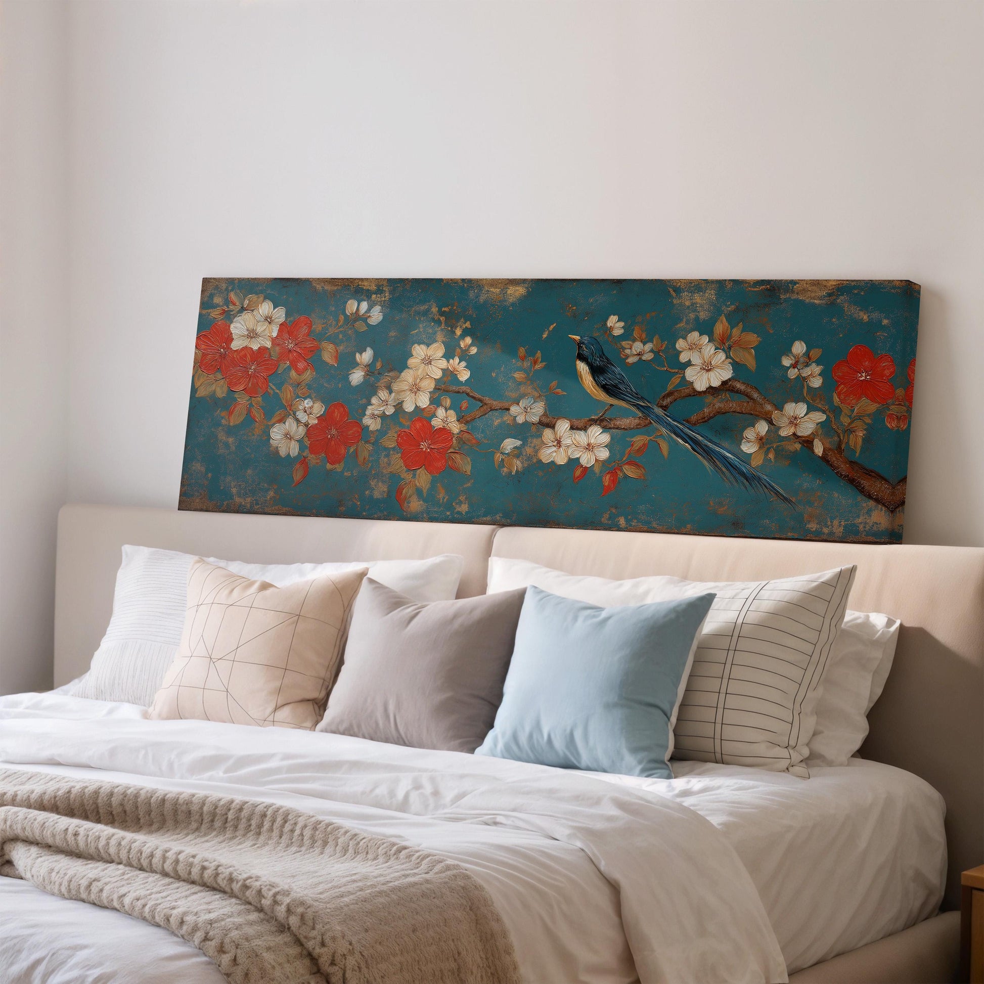 a large bed with a blue floral print headboard, and the bed is adorned with various pillows and a blanket.